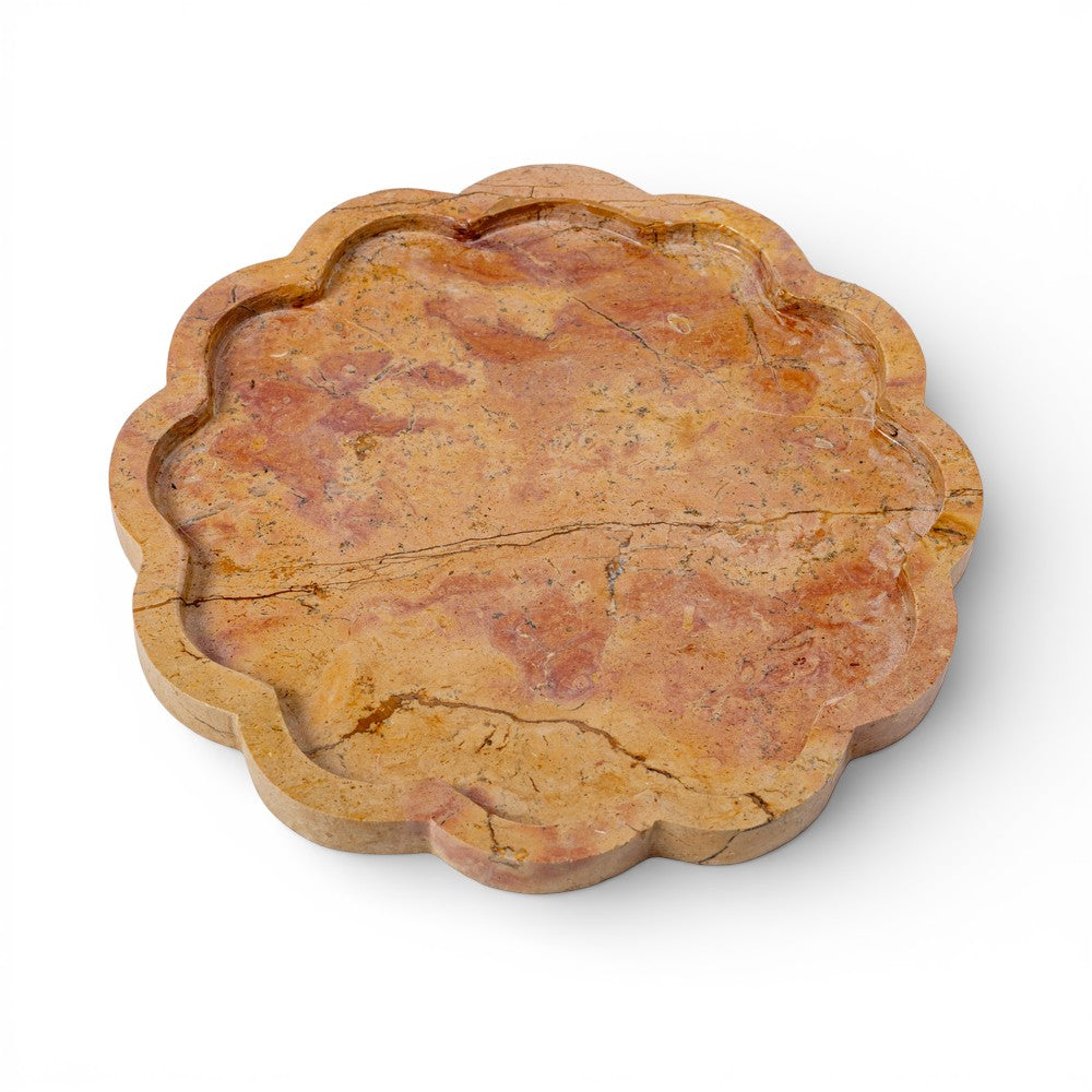 Decorative stone coaster with scalloped edge on a white background