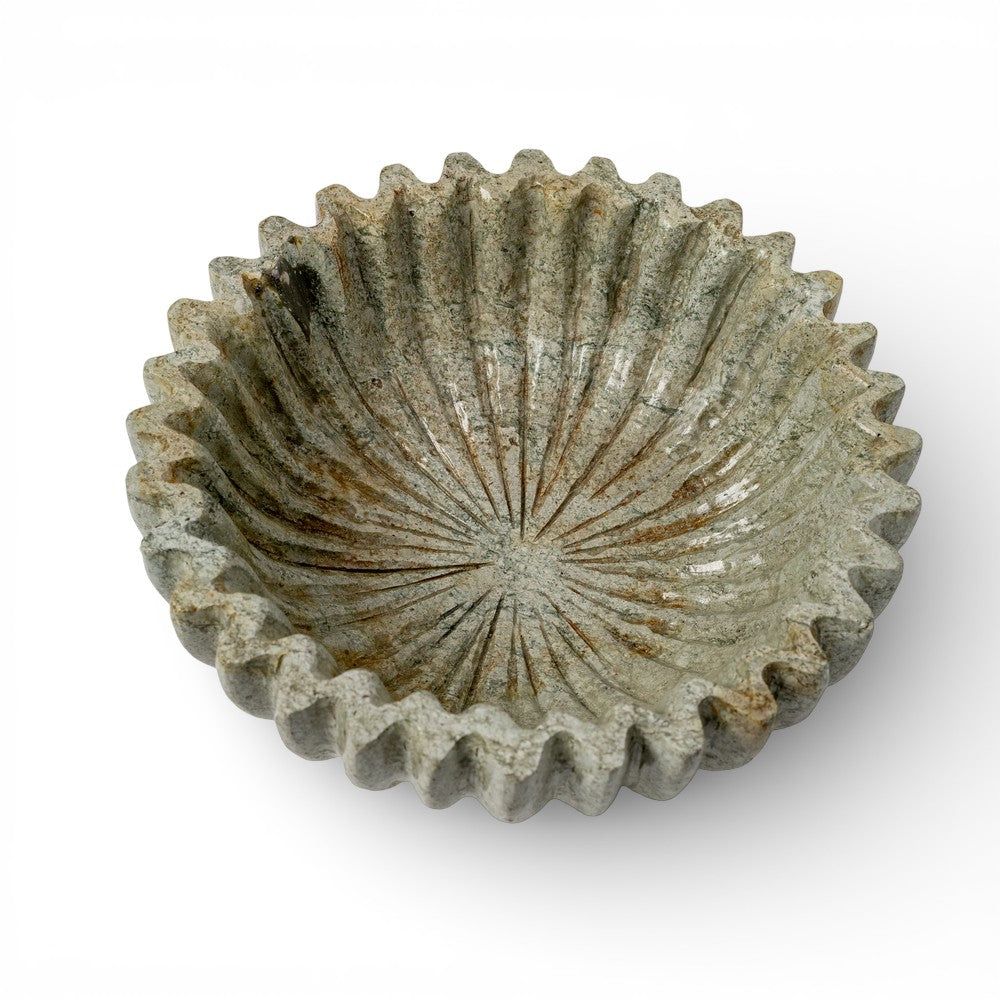 Decorative stone bowl with a textured surface on a white background