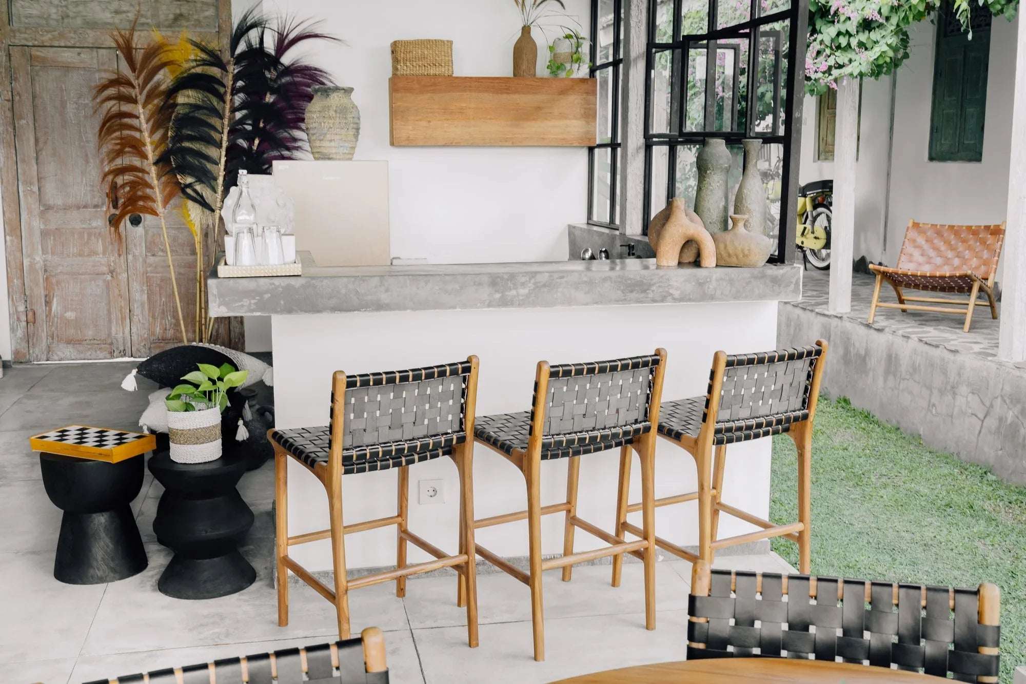 Modern tropical interior with woven bar stools, natural décor, handmade furniture by Kayu Living