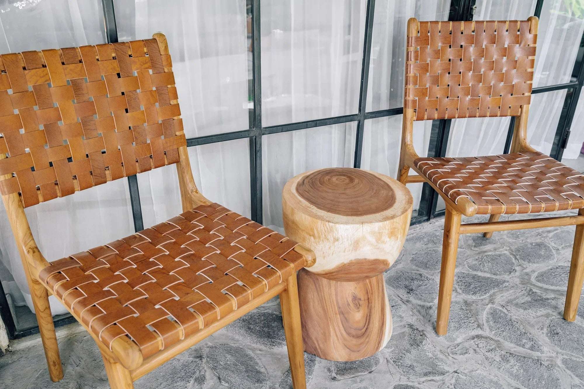 Handcrafted wooden chairs with woven leather seats and a solid wood side table by Kayu Living