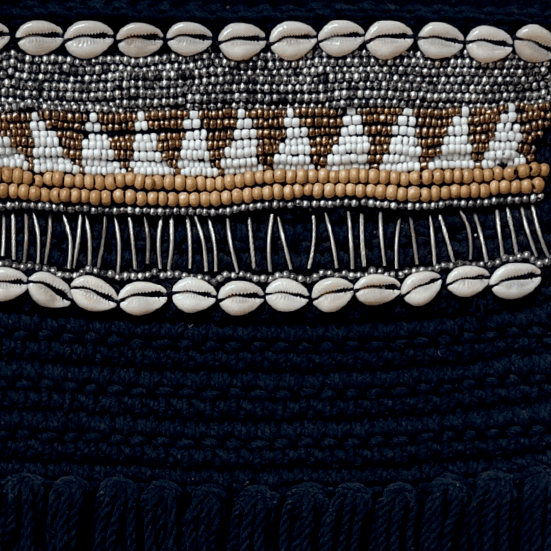Close-up of a black fabric with bead and shell pattern