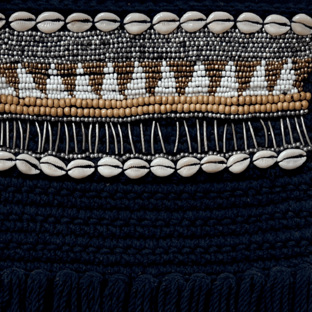 Close-up of a black fabric with bead and shell pattern
