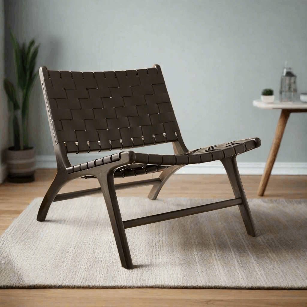 Brown woven chair in a room with a table and plant