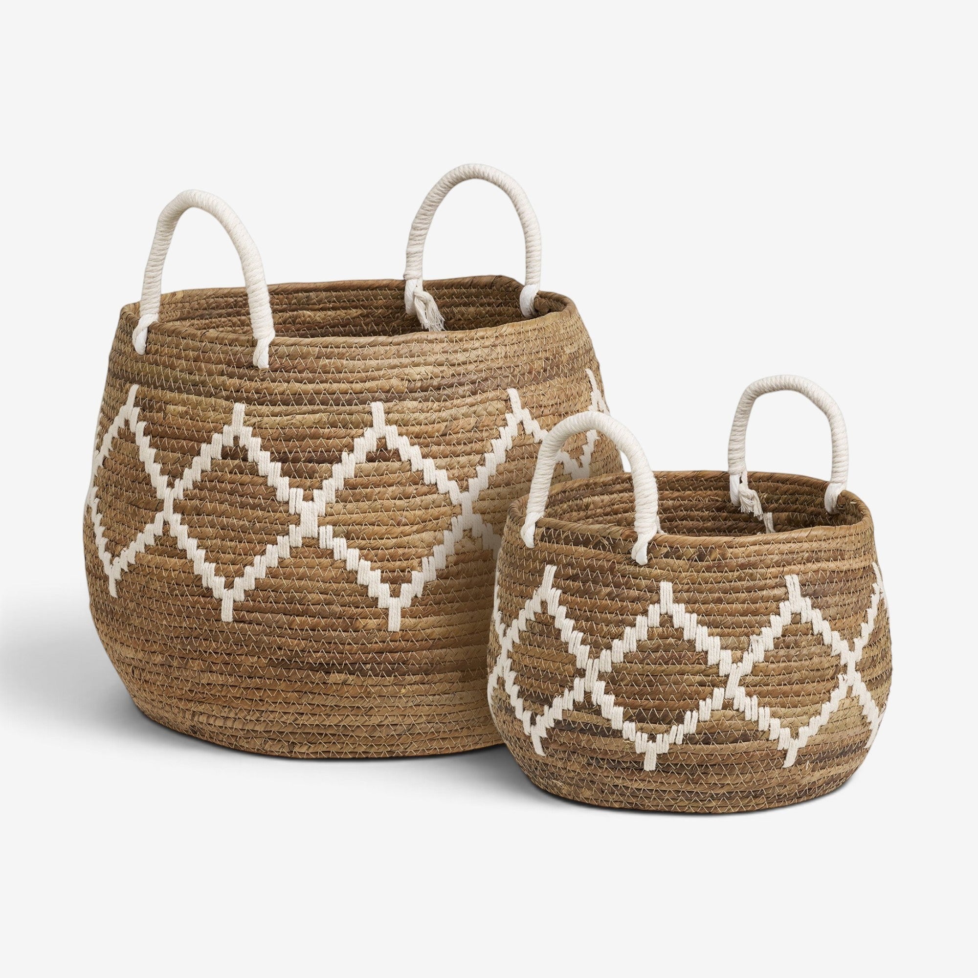 Kayu Living Altea set of two handcrafted banana-leaf storage baskets with natural and ivory geometric patterns.
