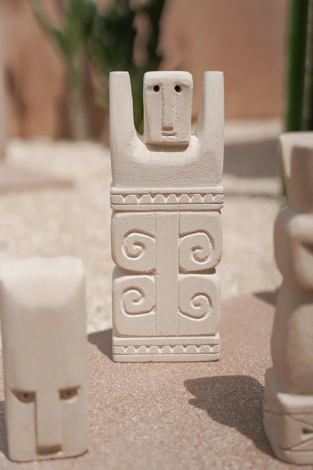 Kayu Living handcrafted Balinese natural stone guardian figurine with carved spiral patterns and protective symbolism.