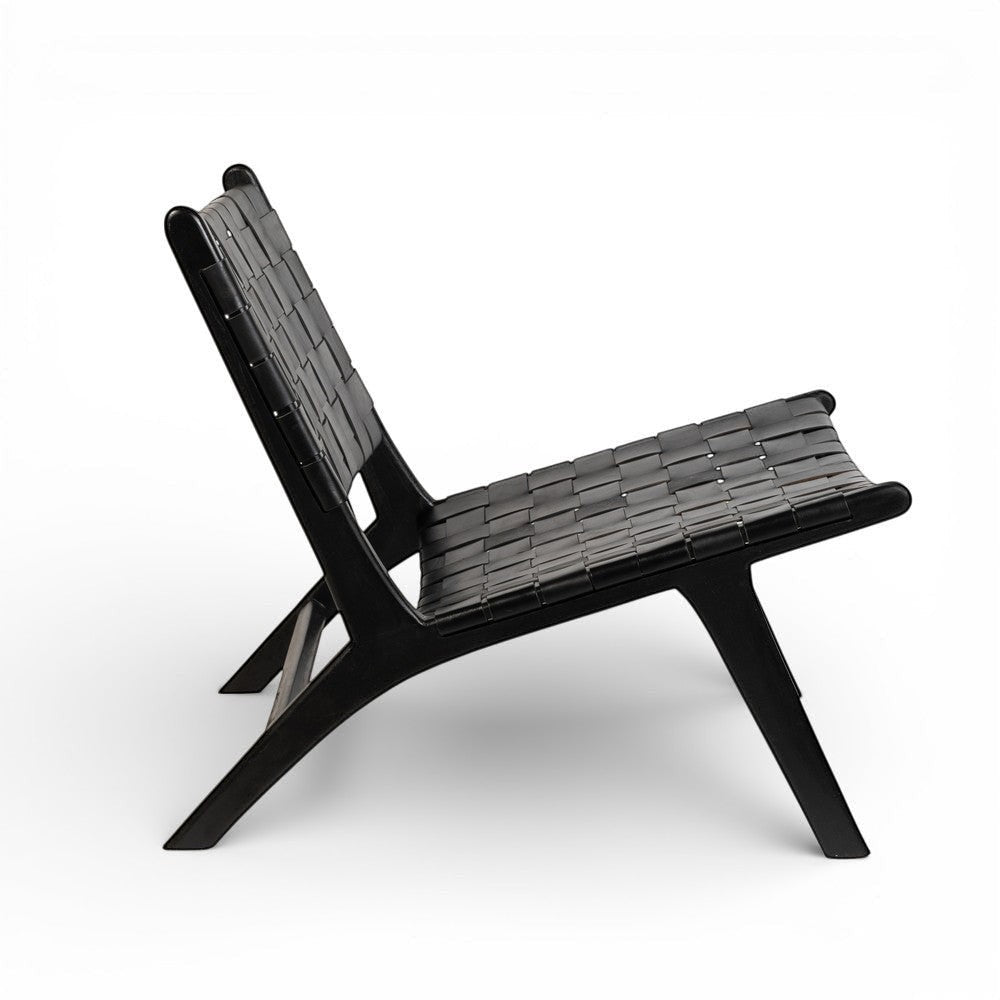 Kayu Living 'Hitam' lounge chair with black handwoven leather seat and black teak frame. Modern design.