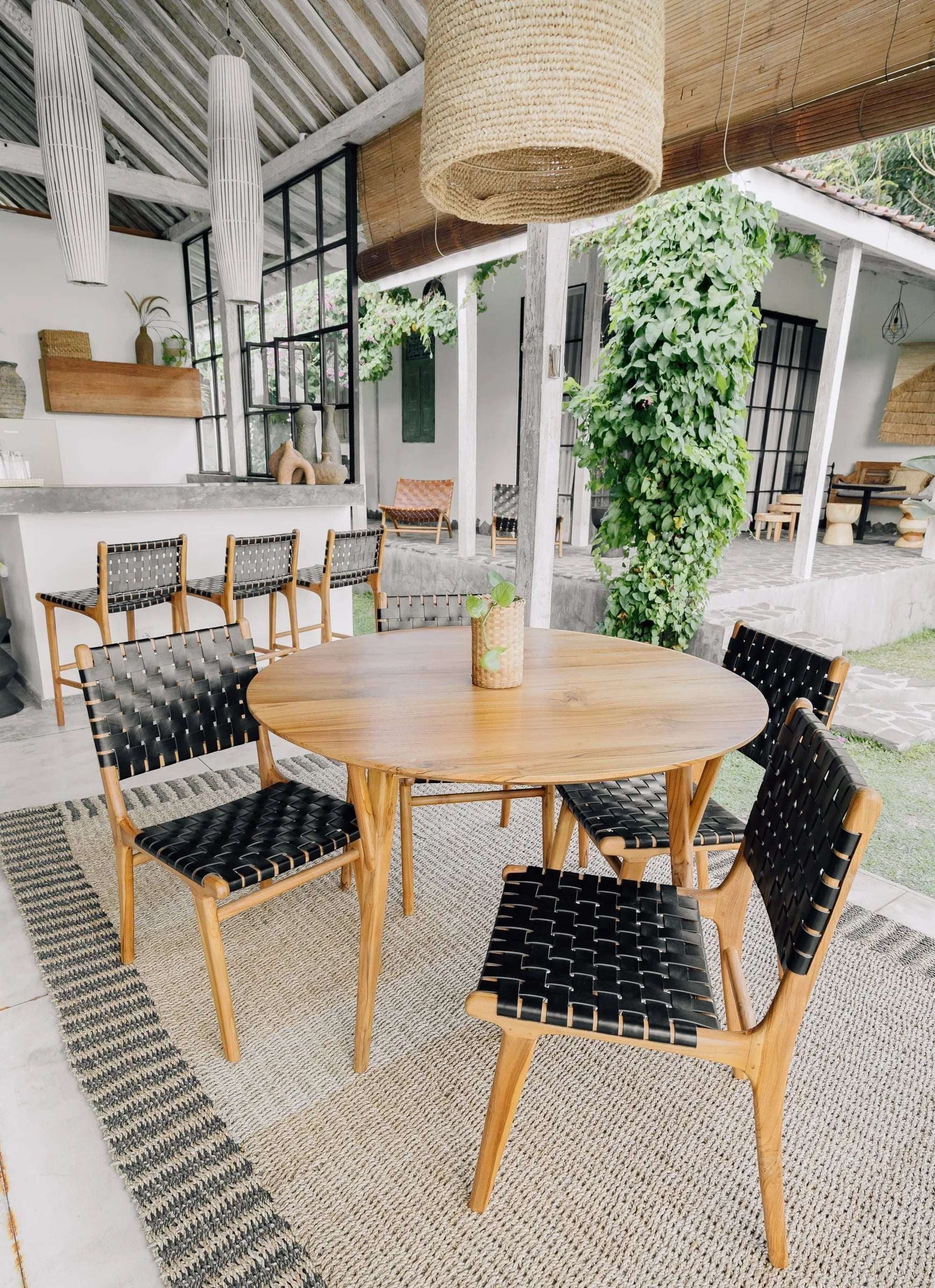 Kayu Living Umalas counter stool with black woven leather seat and teak frame, ideal for kitchen counters or bar areas.