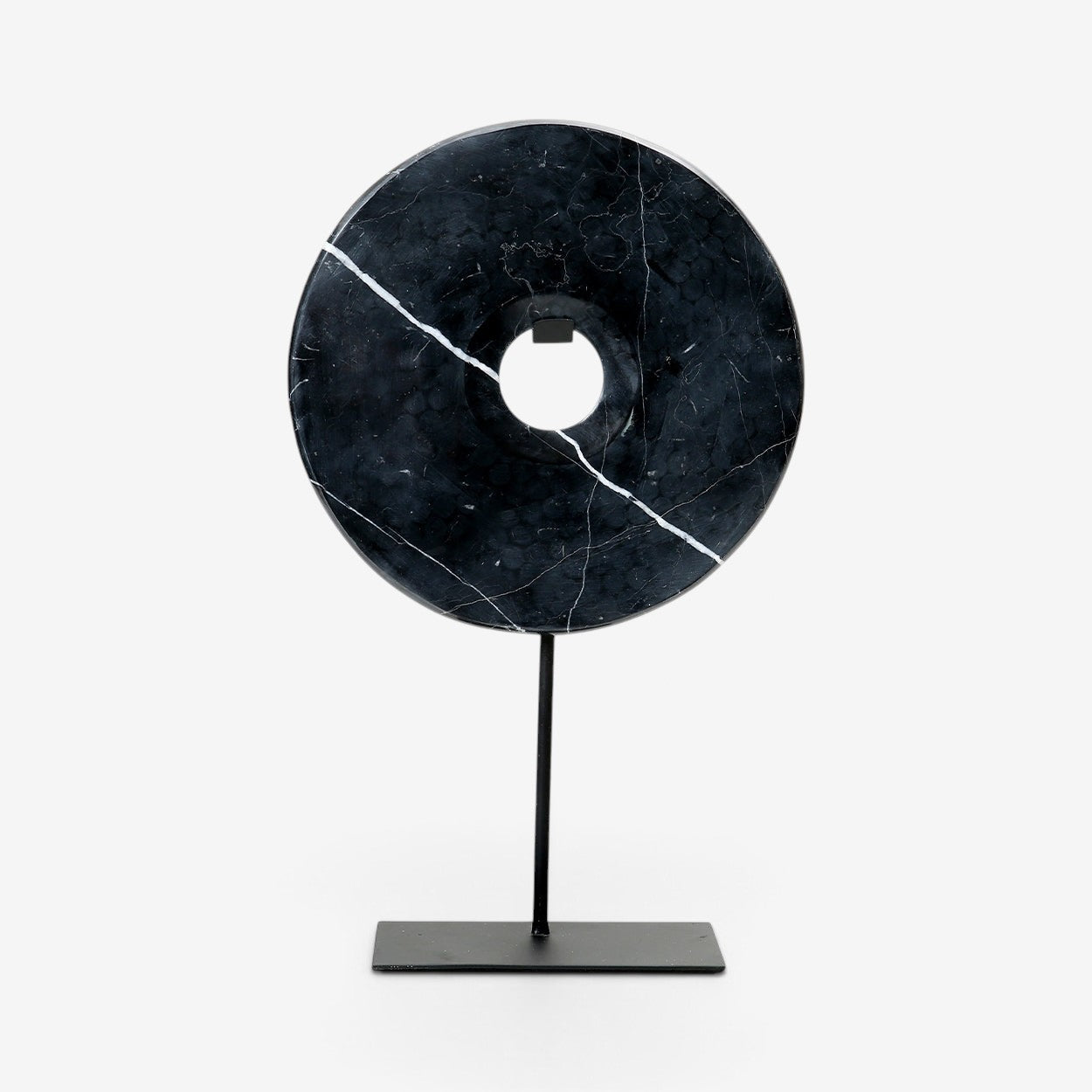 Kayu Living large black marble disc sculpture on a minimalist black metal stand with natural white veining details.