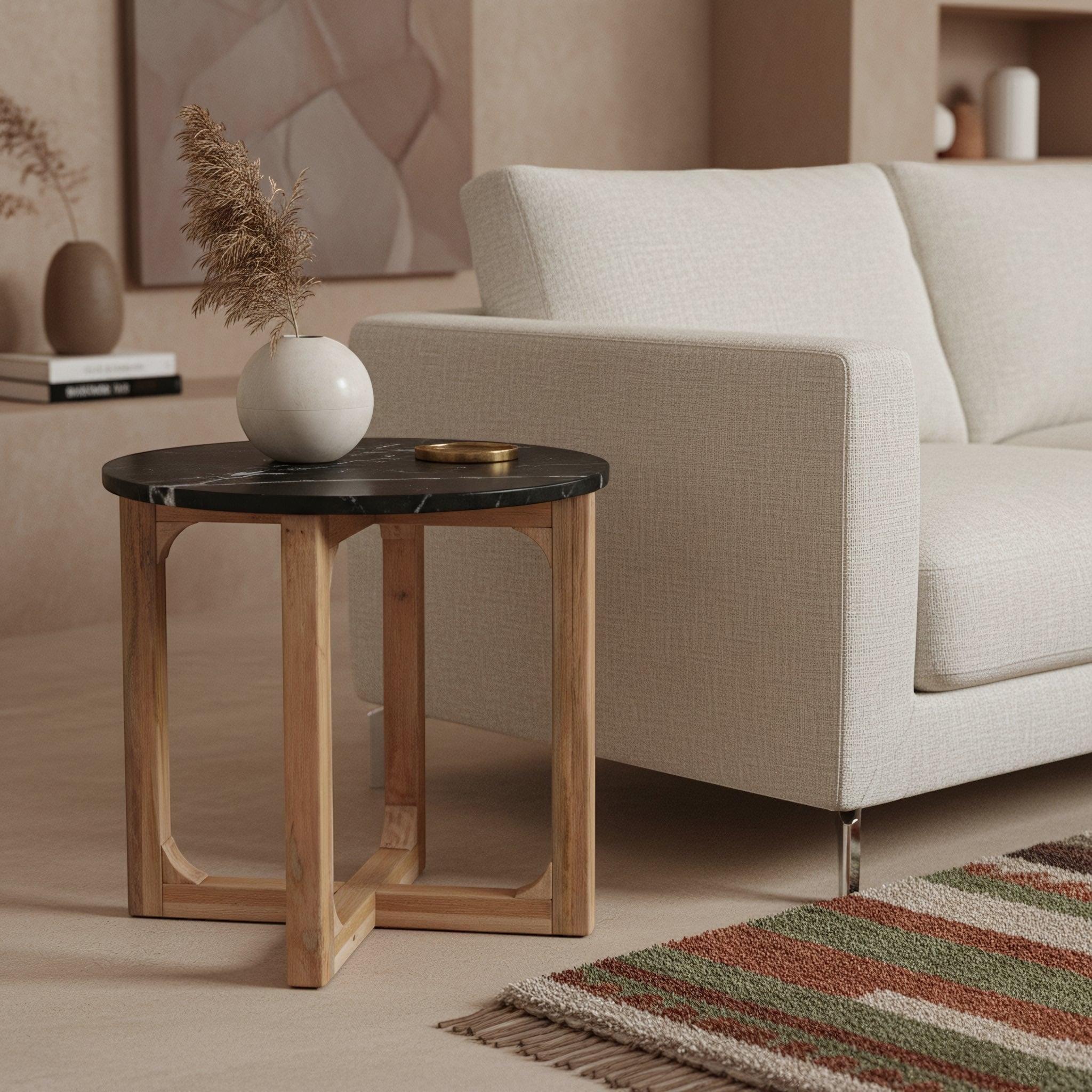 Kayu Living round side table with black marble top and white veining on a crossed light mango wood base.