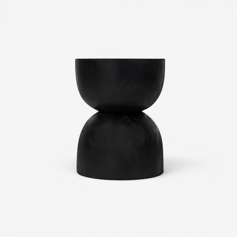 Kayu Living black hourglass stool made from solid suar wood with unique natural grain and rustic charm.