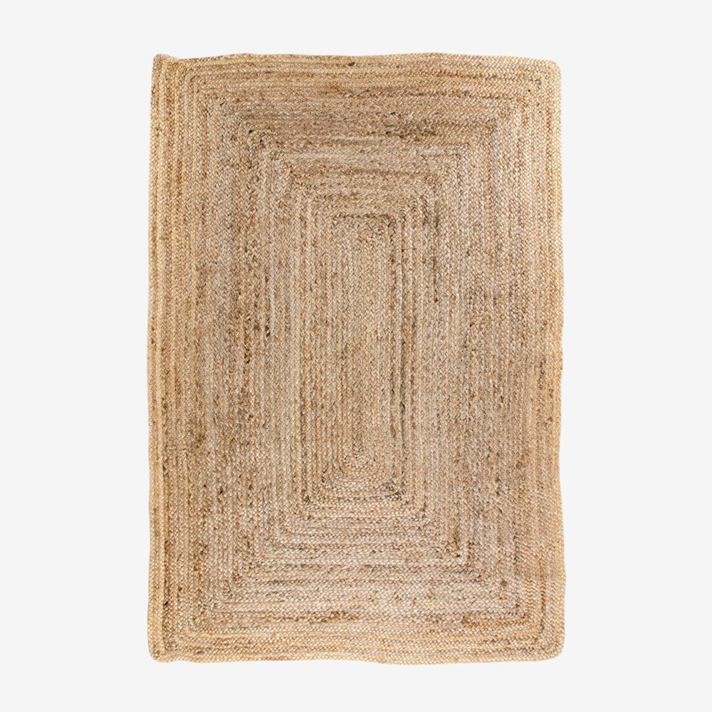 Kayu Living Bombay braided jute rug in natural, 120 x 180 cm, featuring a concentric rectangular pattern and rustic texture.
