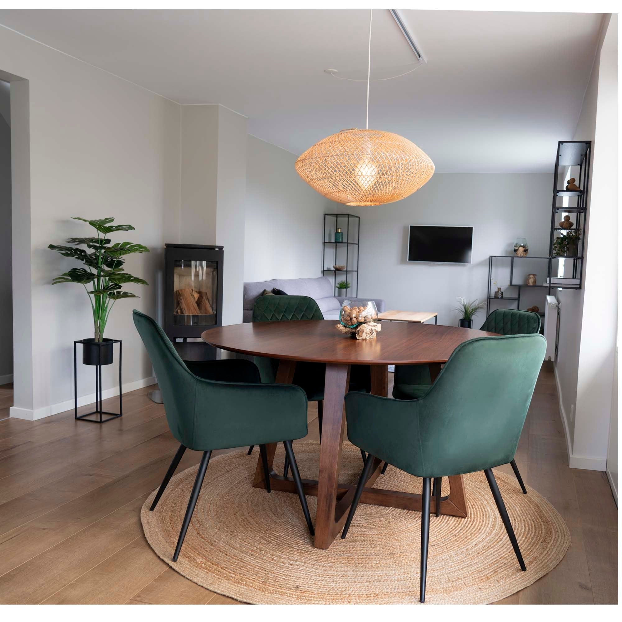 Kayu Living braided jute rug, natural, 180 cm diameter, adds rustic elegance to dining area with green velvet chairs.
