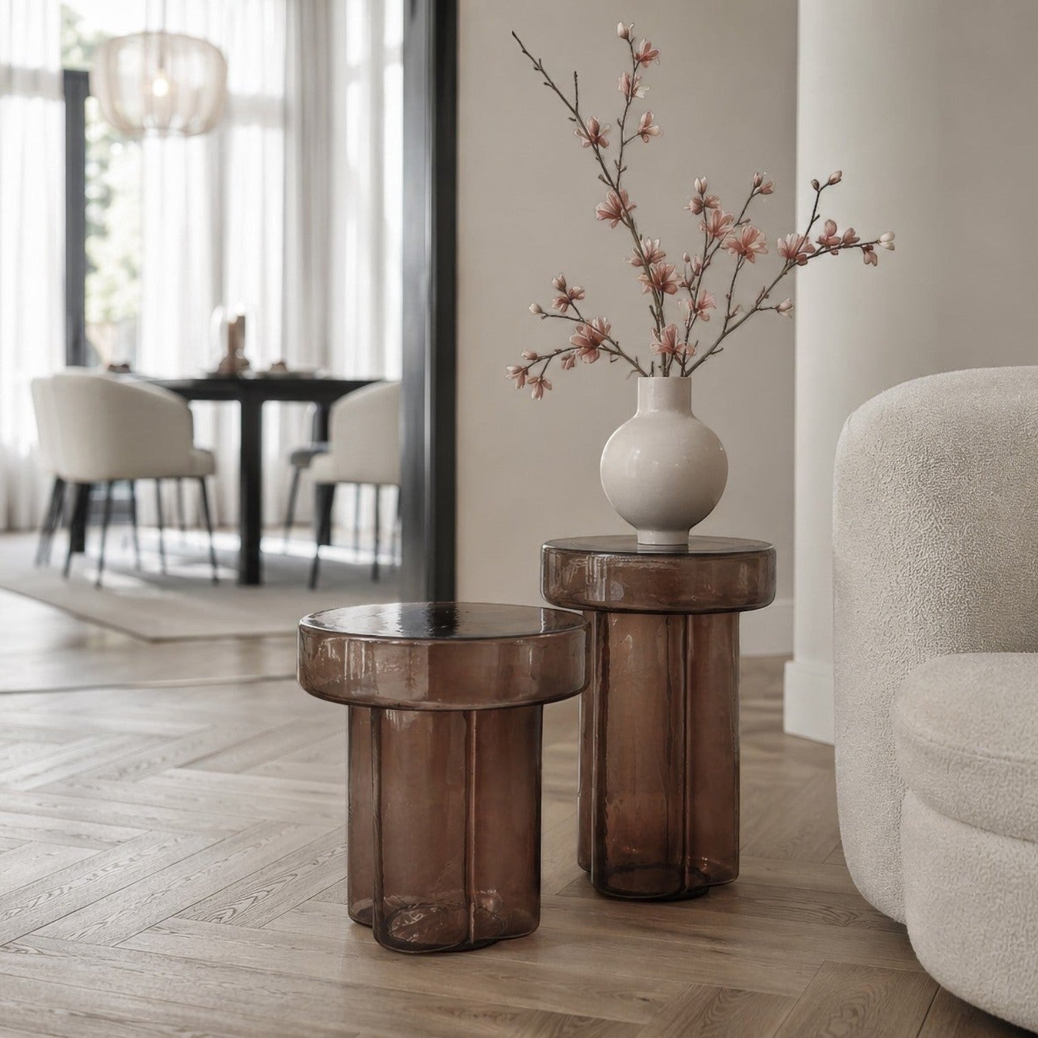 Kayu Living Brix Lio smoked brown glass side tables with fluted cylindrical bases in a modern living room setting.