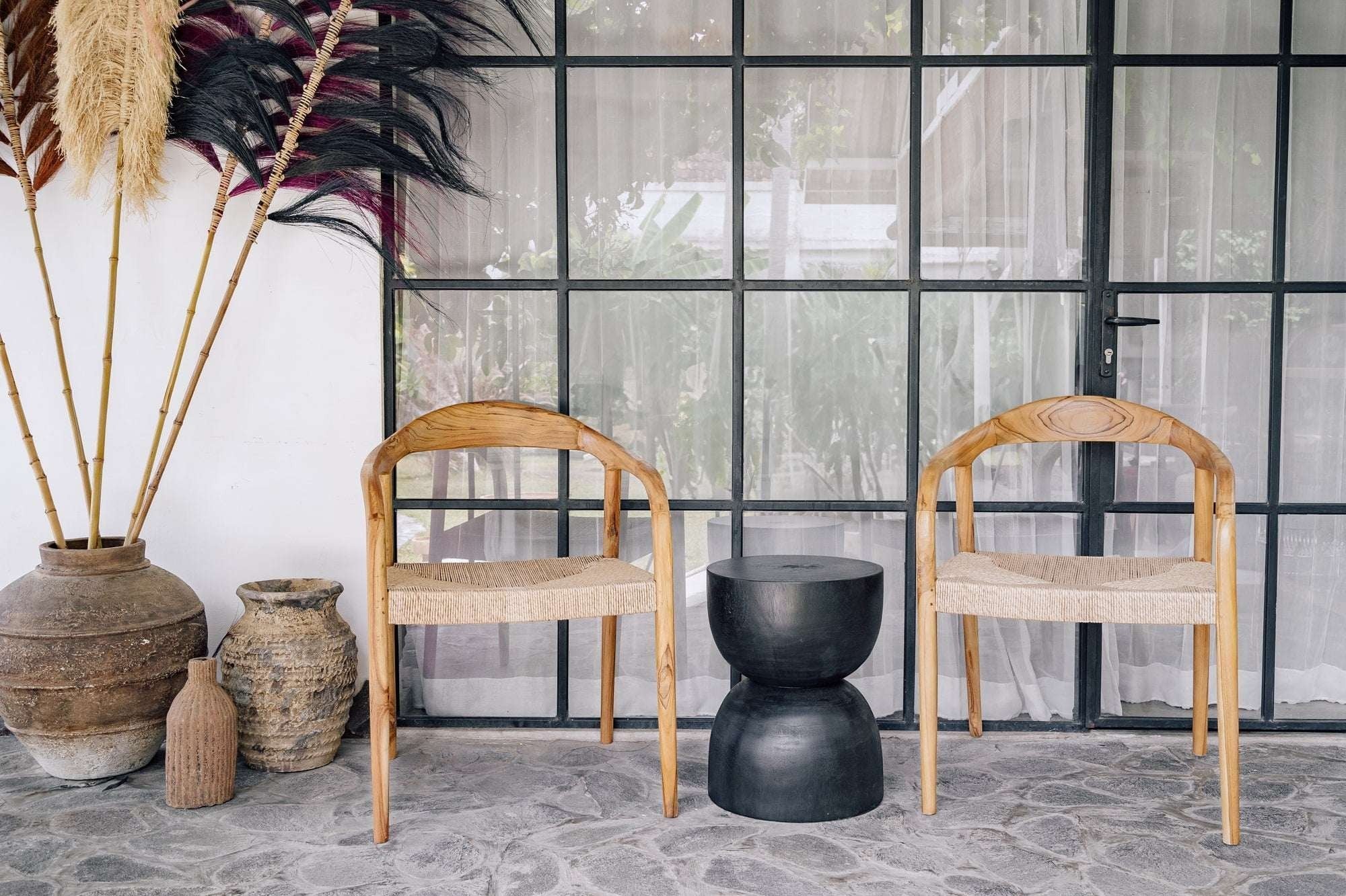 Kayu Living Cemagi chair with natural teak frame and handwoven rope seat, suitable for indoor/outdoor use.
