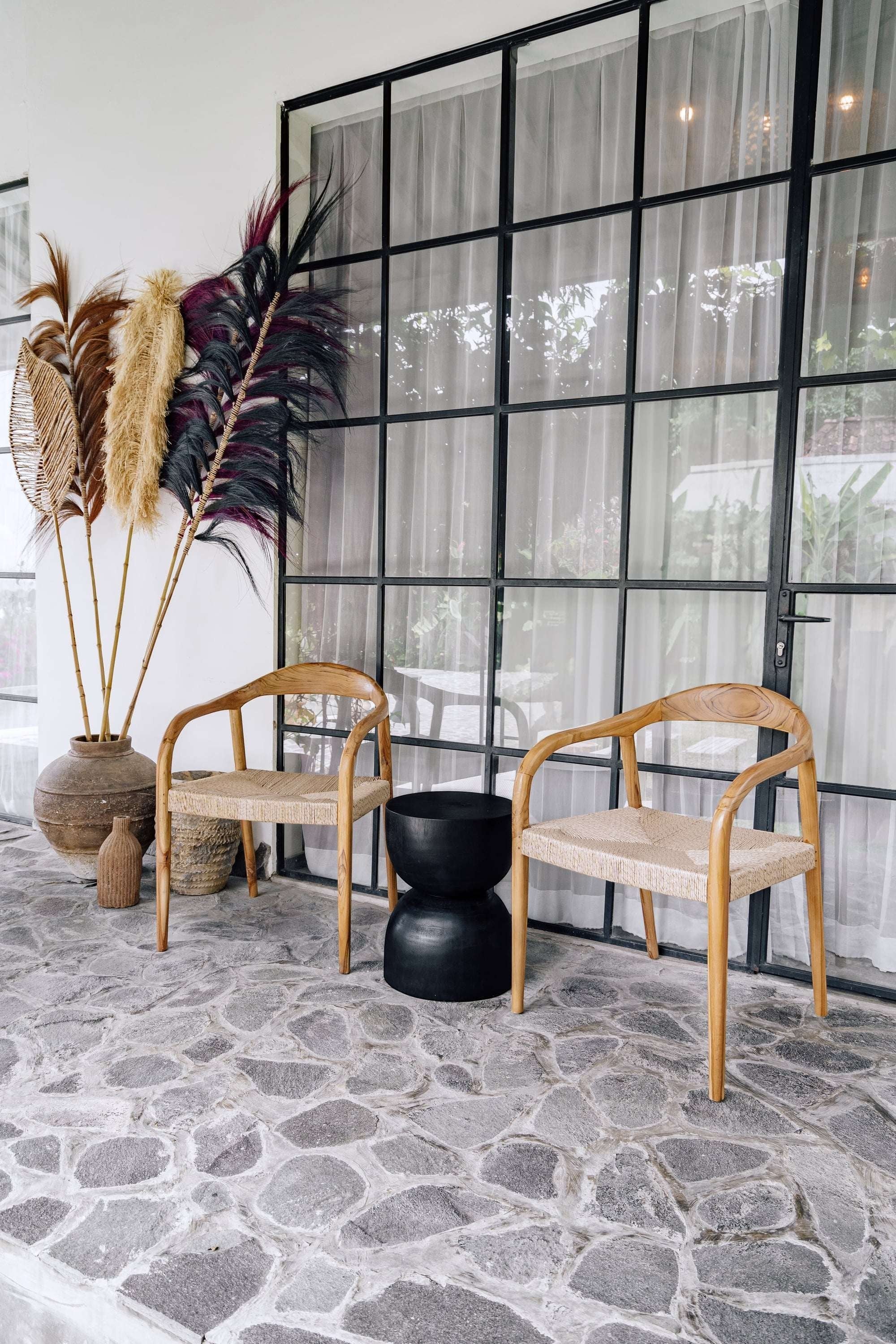 Kayu Living Cemagi chair with teak frame and handwoven rope seat, suitable for indoor/outdoor use.