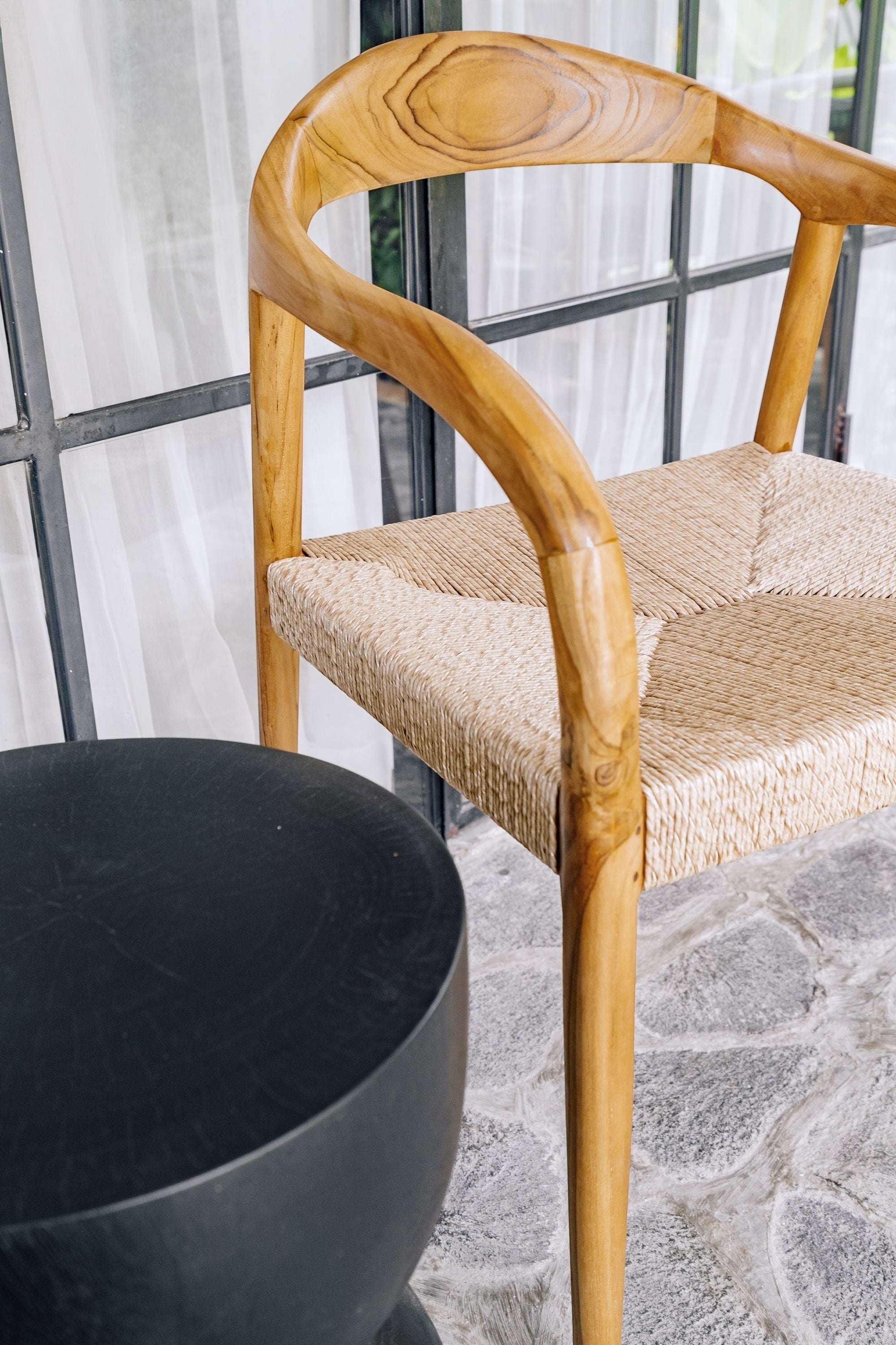 Kayu Living Cemagi chair with natural teak frame and woven rope seat, suitable for indoor/outdoor use.