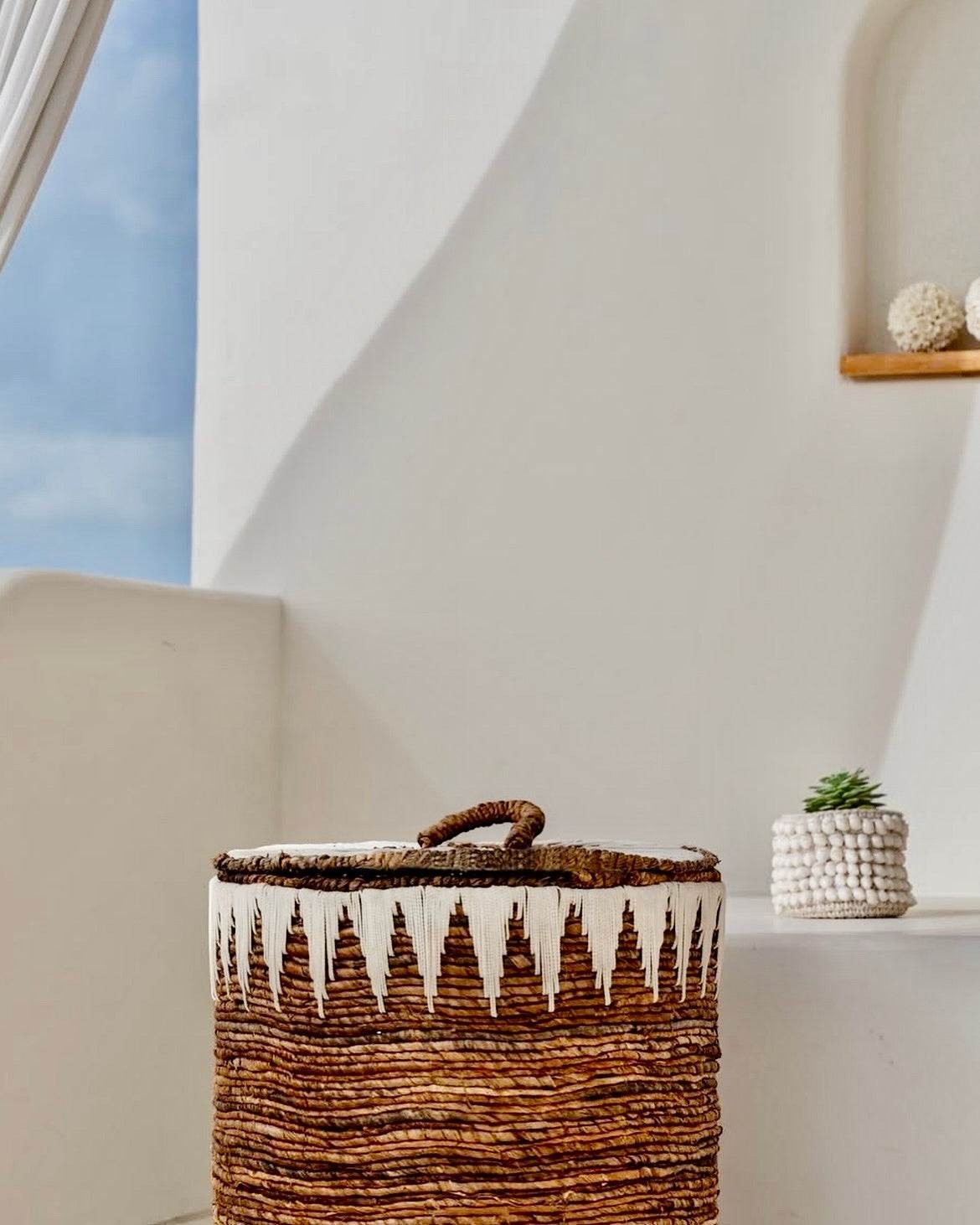 Kayu Living brown banana cord storage basket with lid and white embroidered detail. Natural woven texture.