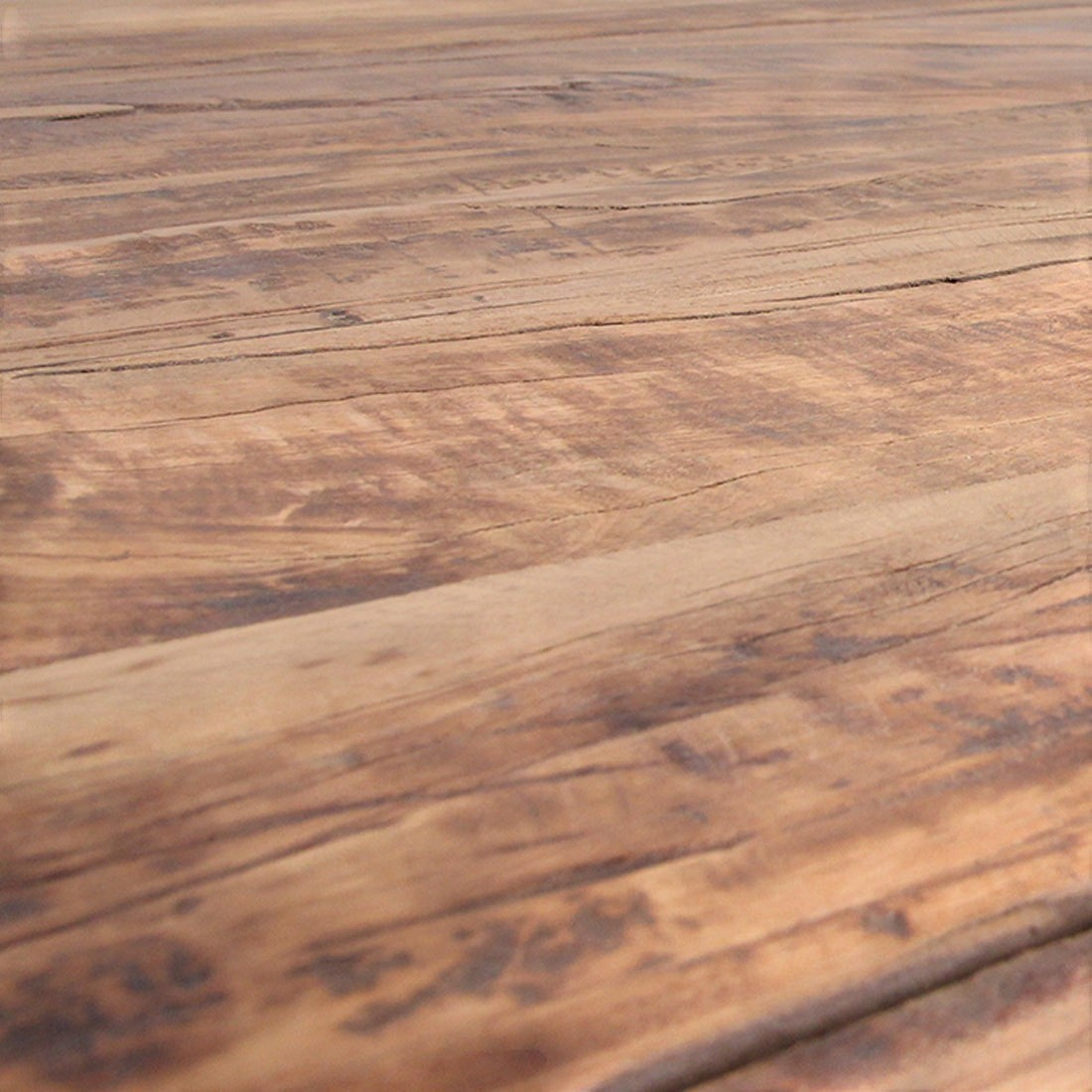 Close-up of Kayu Living Farmwood dining table surface showing natural brown recycled wood grain, knots, and texture.