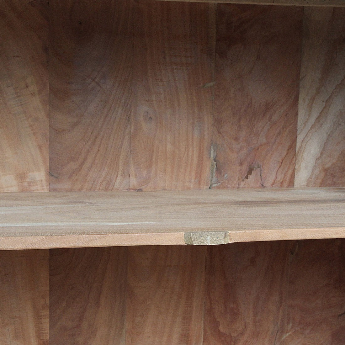 Close-up of the interior shelf of a Kayu Living Farmwood sideboard, showing natural FSC recycled wood grain.