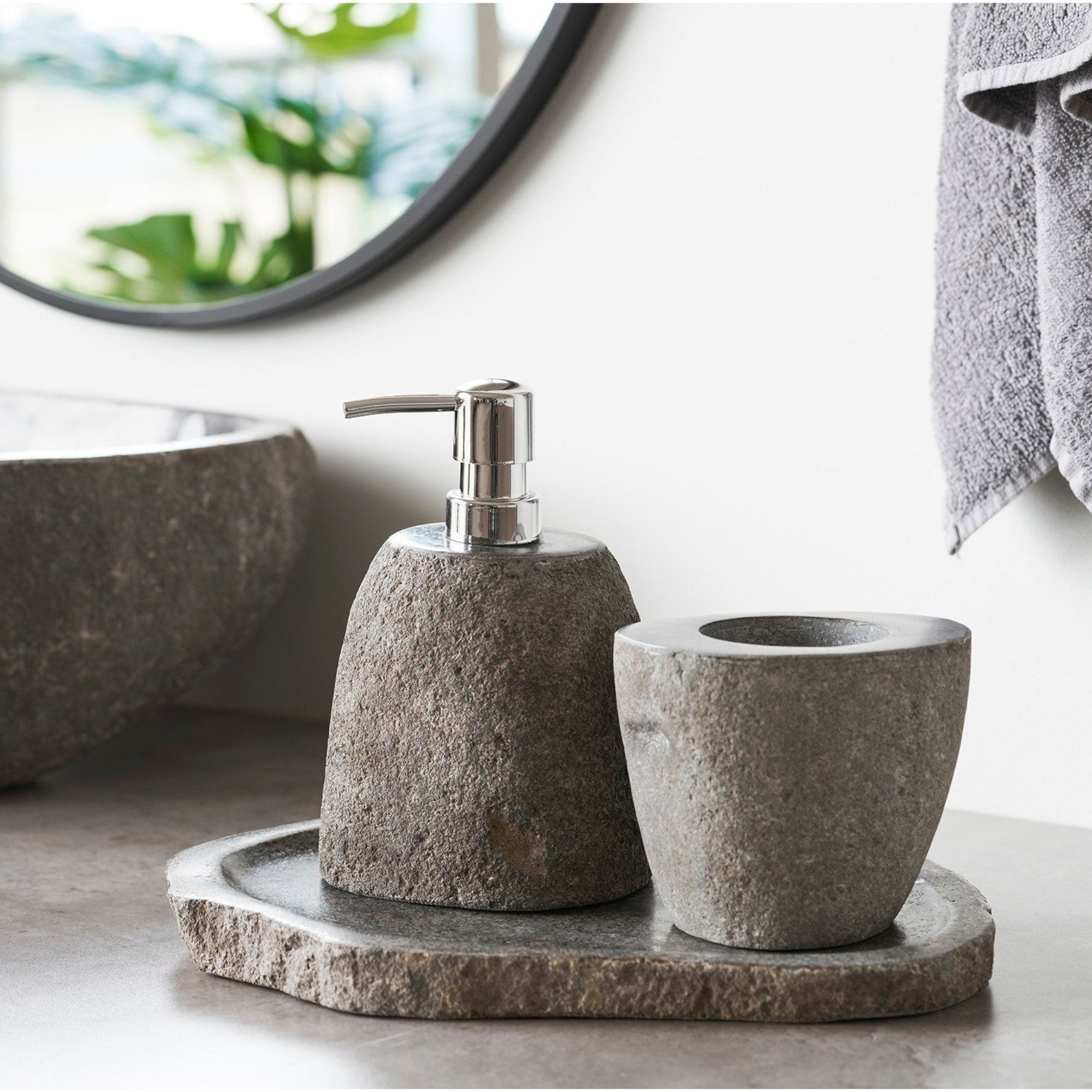 Kayu Living Gara natural riverstone tray with a matte finish holding a stone soap dispenser and cup in a bathroom