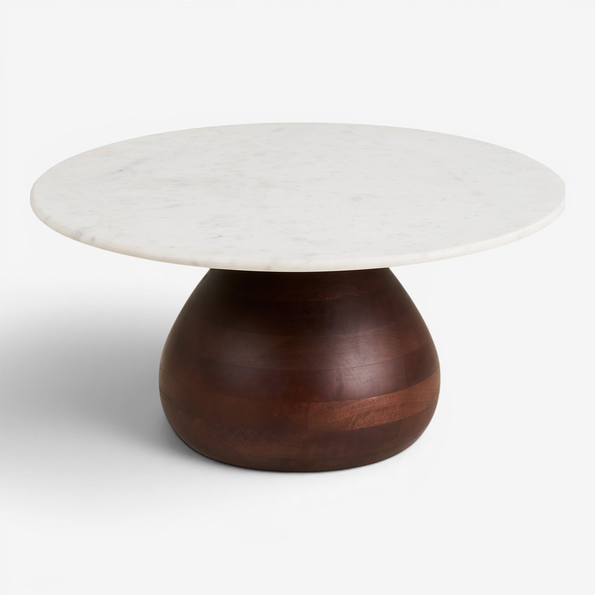 Kayu Living Heide round coffee table with a white marble top and a sculptural dark brown mango wood base.