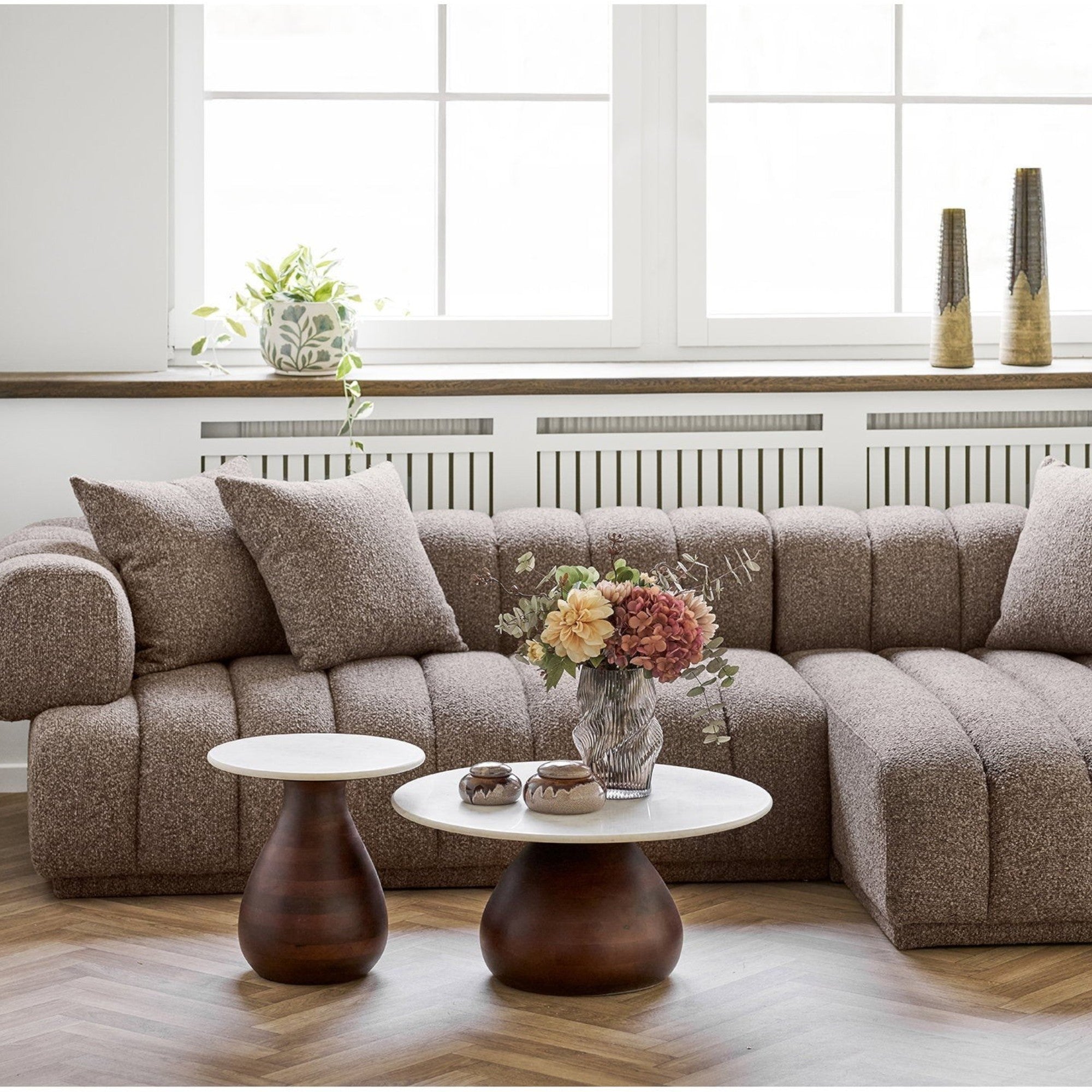 Kayu Living Heide side table with dark-brown mango wood base and white marble top in a modern living room setting.