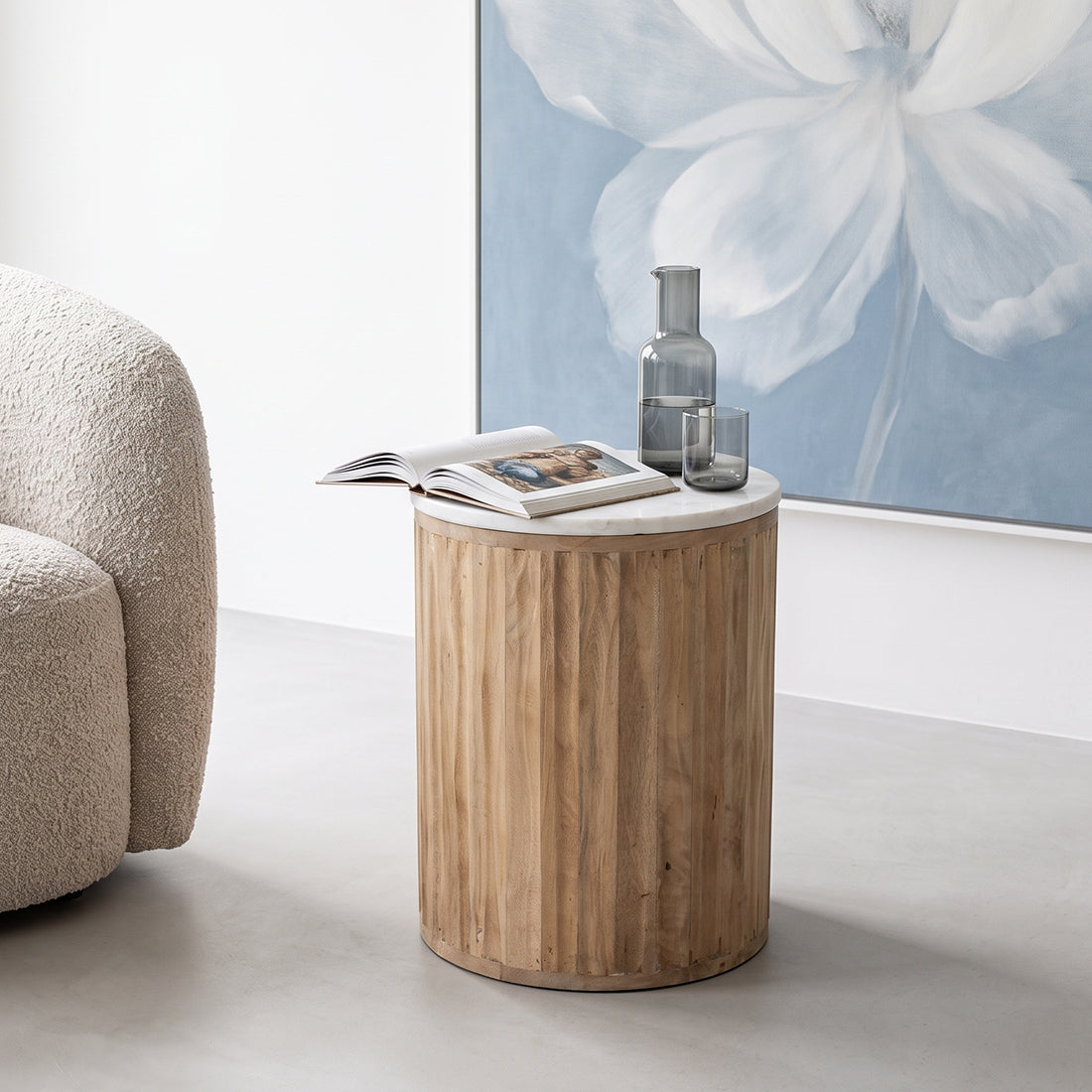 Kayu Living Malakka side table with a round white marble top and a carved cylindrical mango wood base.