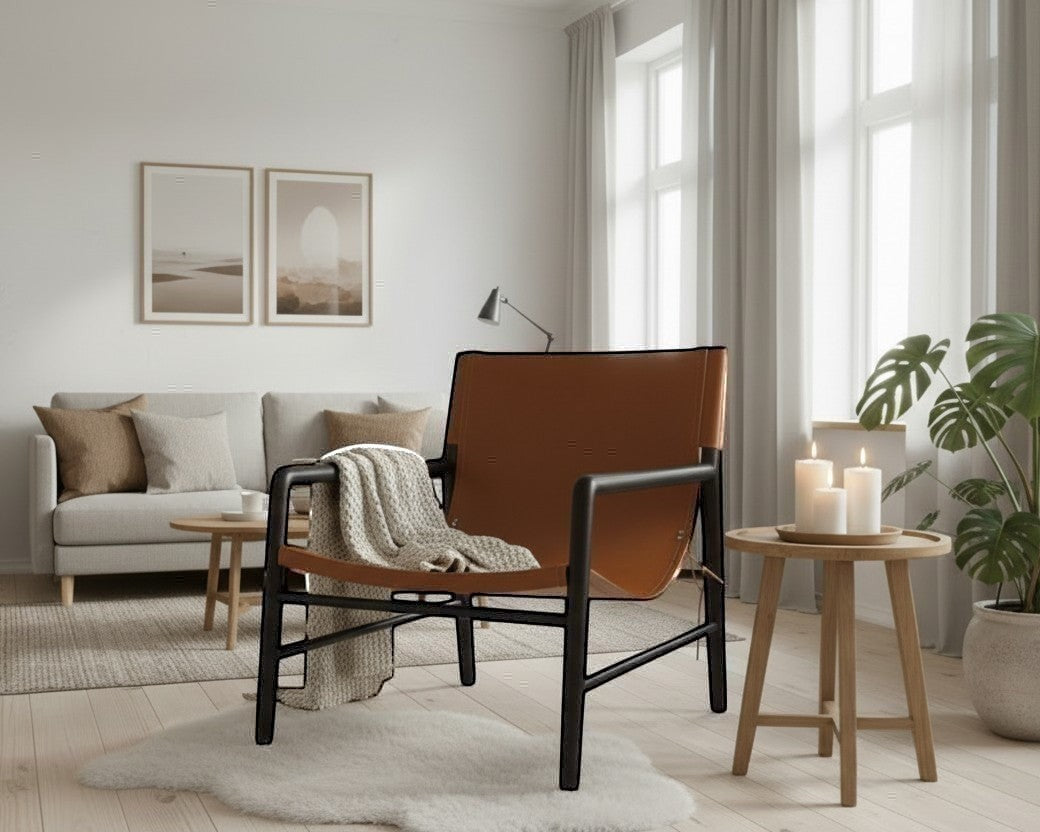 Kayu Living Marita armchair in dark brown teak with cognac leather seat and back, black frame.