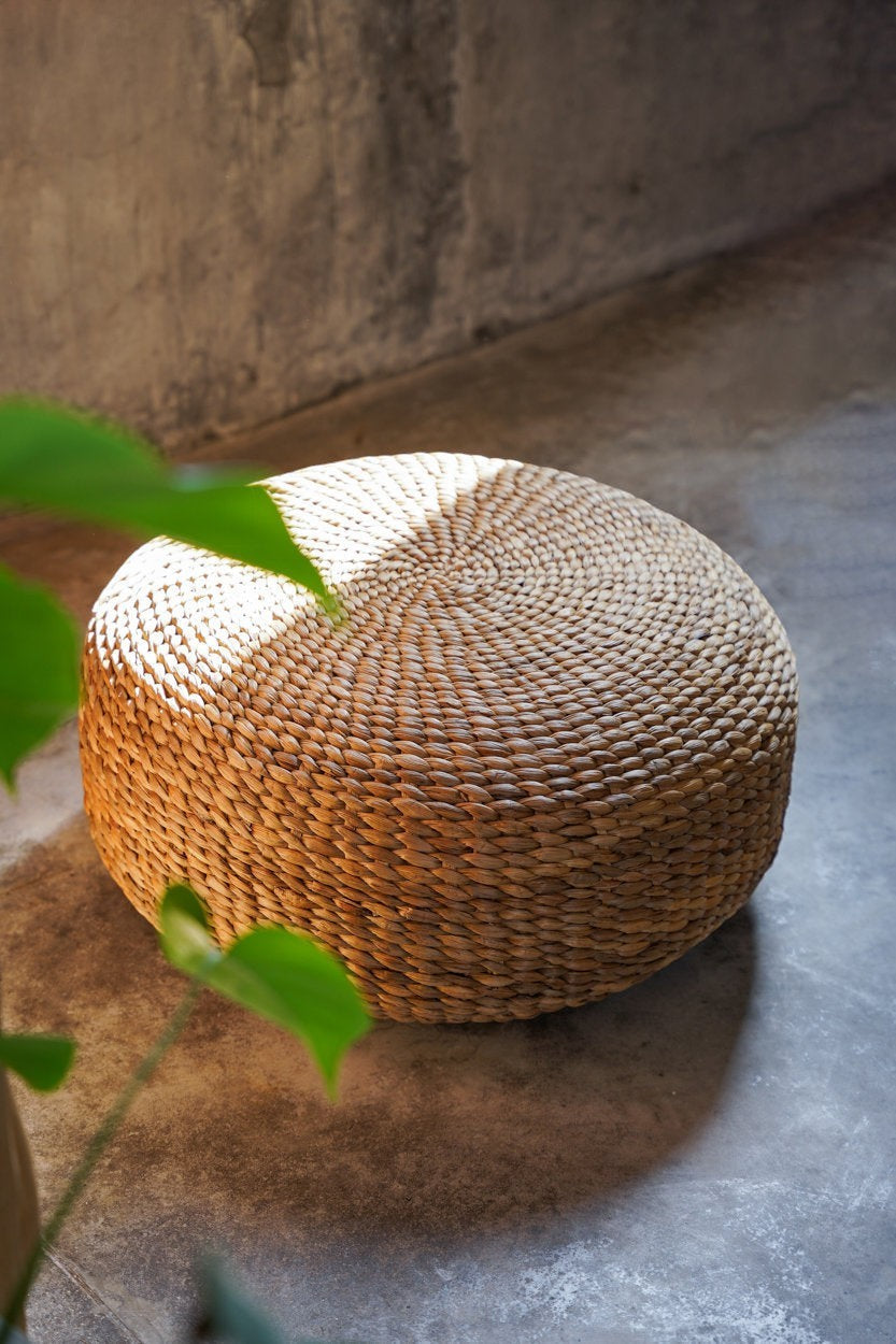 Kayu Living natural water hyacinth pouf with a handwoven round design, perfect as a sustainable floor ottoman.