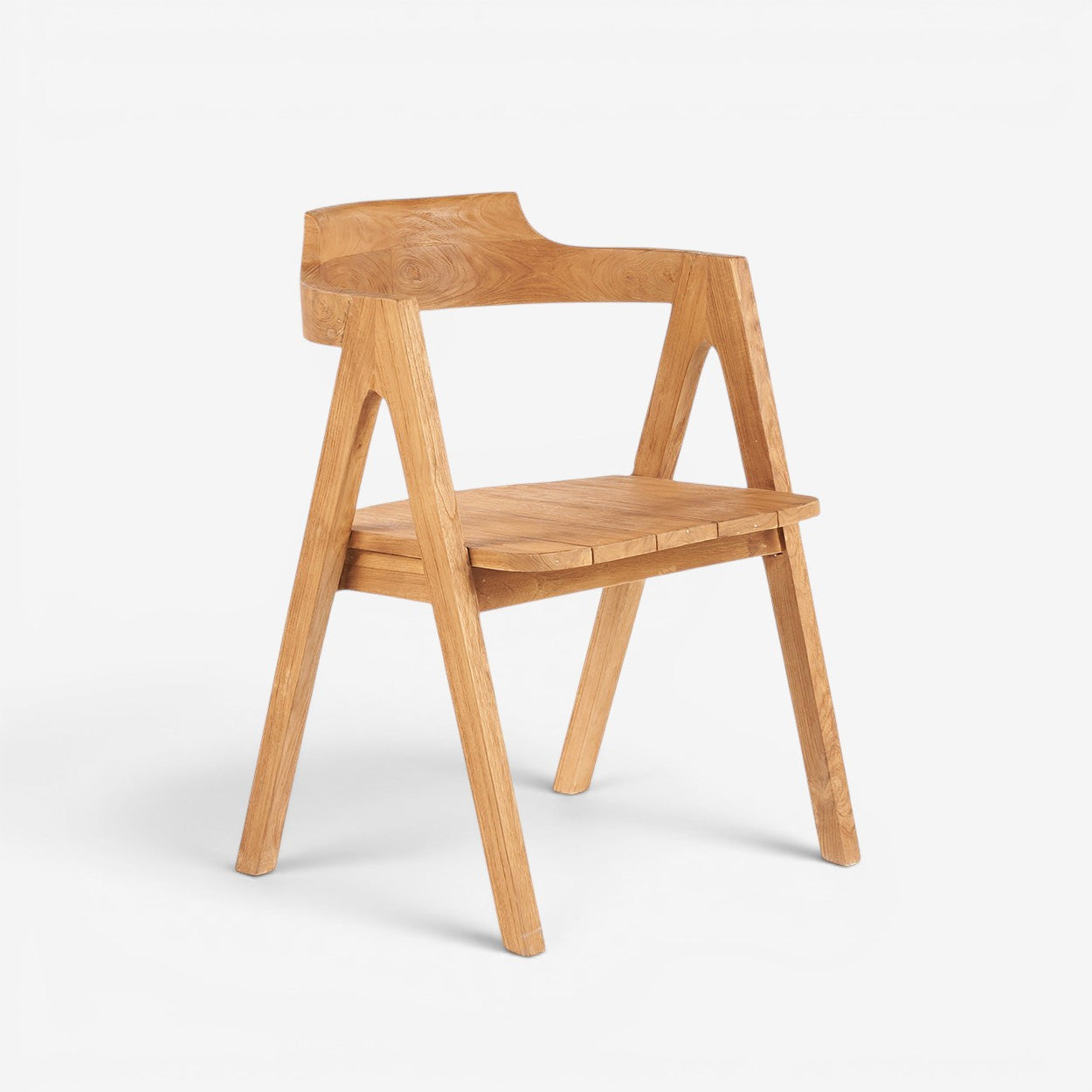 Kayu Living Nihi Sumba outdoor dining chair in natural teak with sculpted curves and crisp lines.