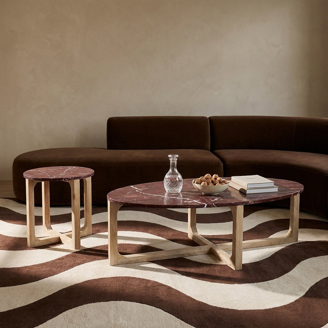 Kayu Living oval marble coffee table in deep bordeaux with white veining on a natural mango wood base. Pairs with matching side table.