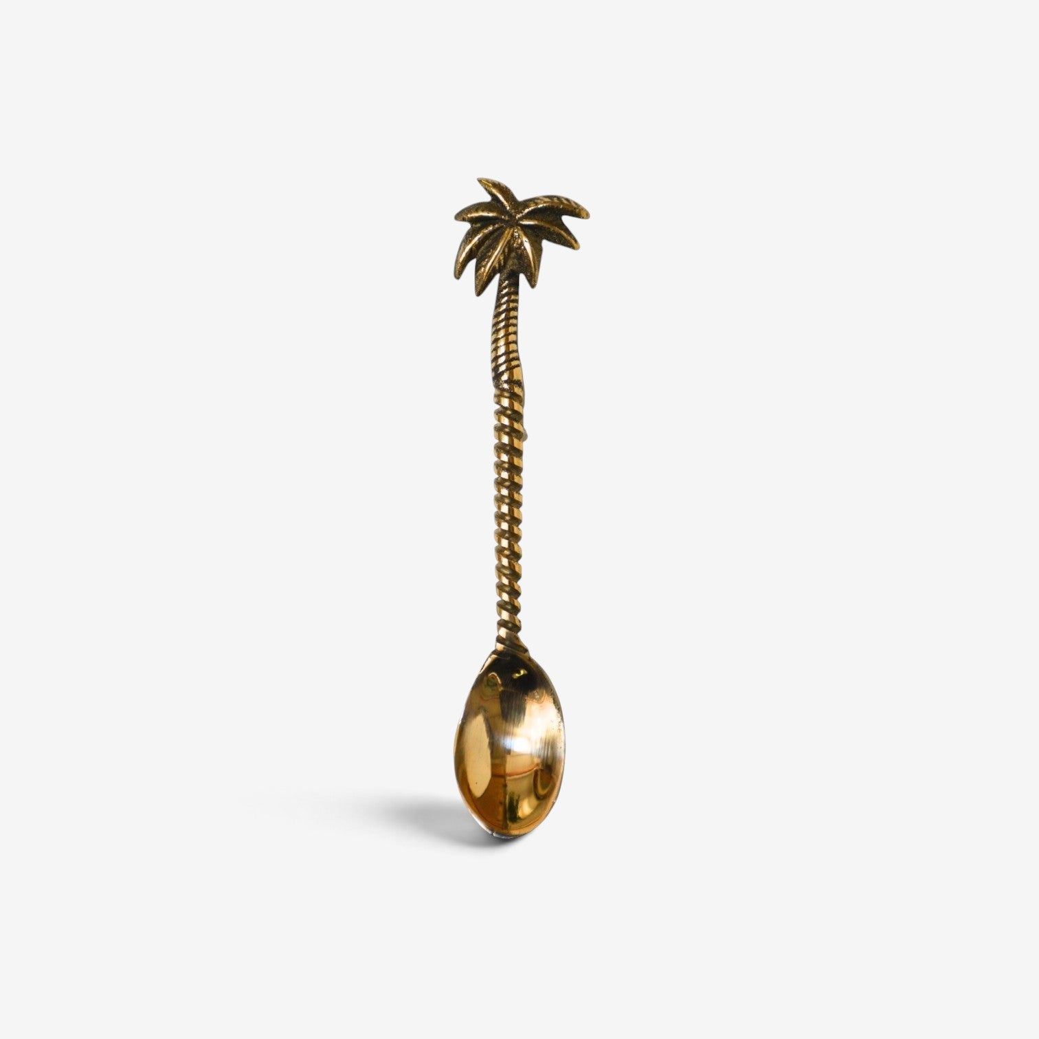 Kayu Living handcrafted gold brass spoon featuring a detailed palm tree design on the handle