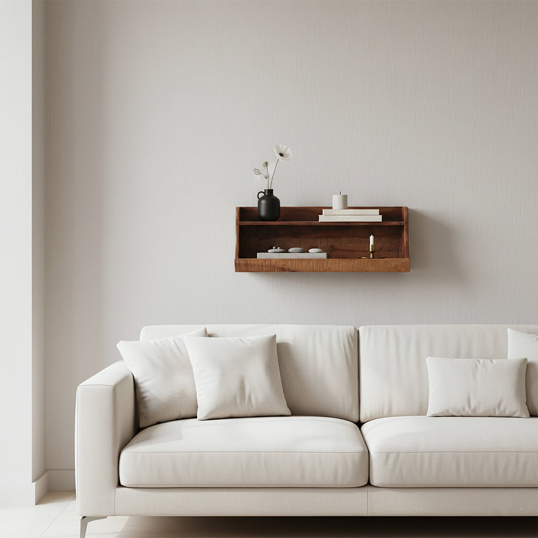 Kayu Living two-tier wall shelf made of dark reclaimed FSC-recycled wood mounted above a beige sofa in a living room.