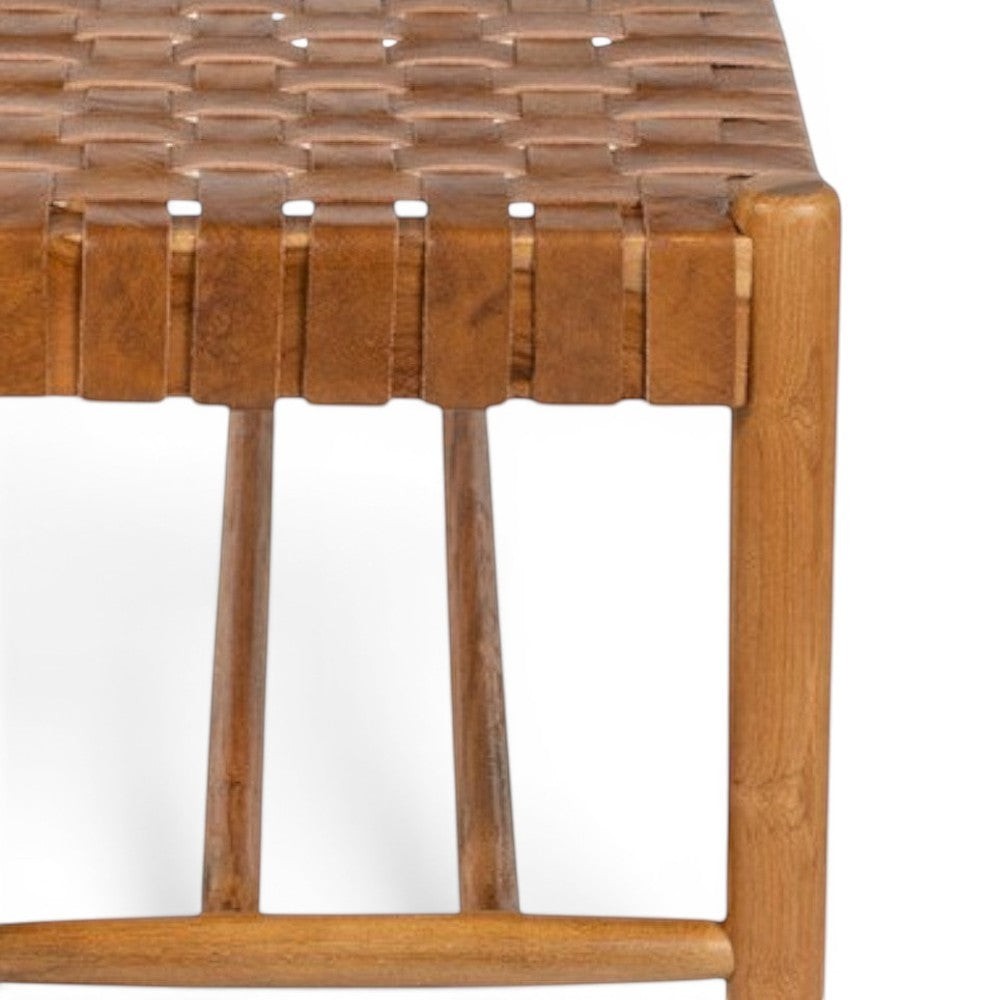 Kayu Living Sanur 120 cm bench with solid teak frame and handwoven camel leather seat. Natural wood and leather.