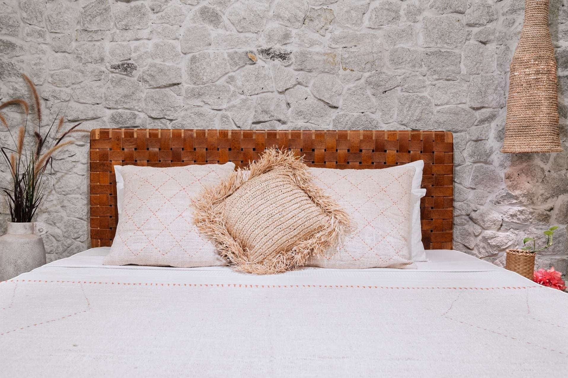 Kayu Living Sanur woven leather headboard with basketweave design in warm brown tones.