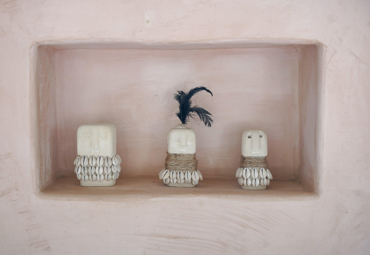 Kayu Living handmade stone figurines with shell and feather accents displayed in a recessed wall niche