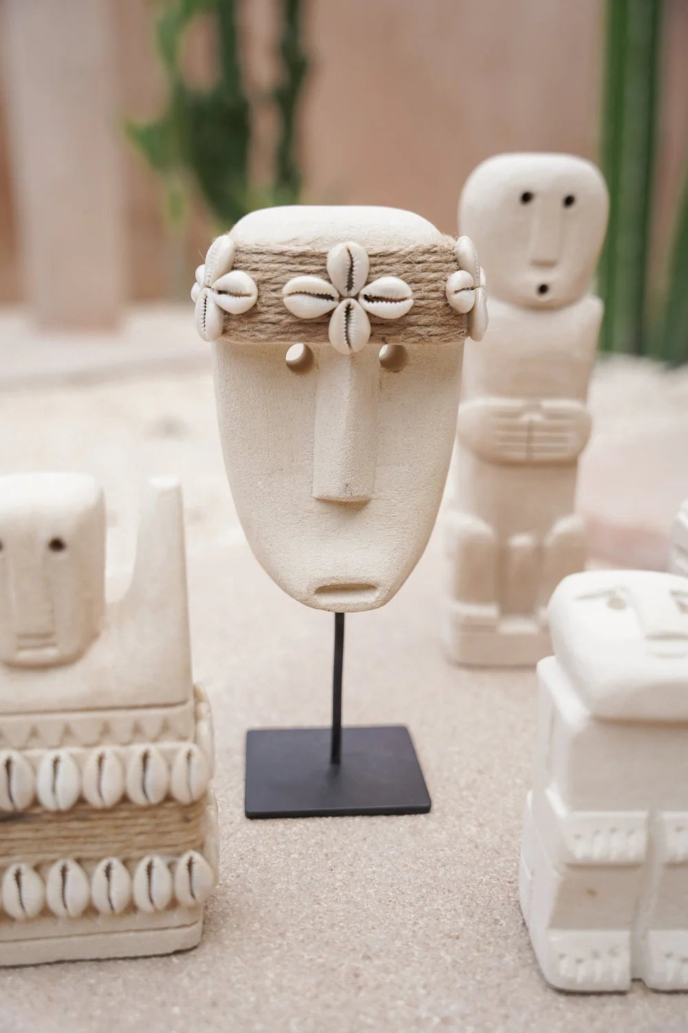Kayu Living handcrafted stone mask figurine with seashell headband on a black metal stand for bohemian home decor