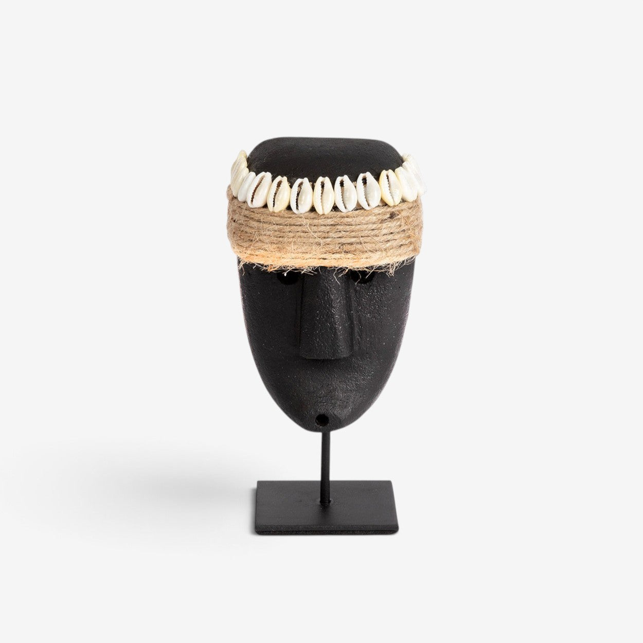 Kayu Living hand-carved black sandstone Sumba statue on a metal stand, adorned with a jute rope and seashell crown.