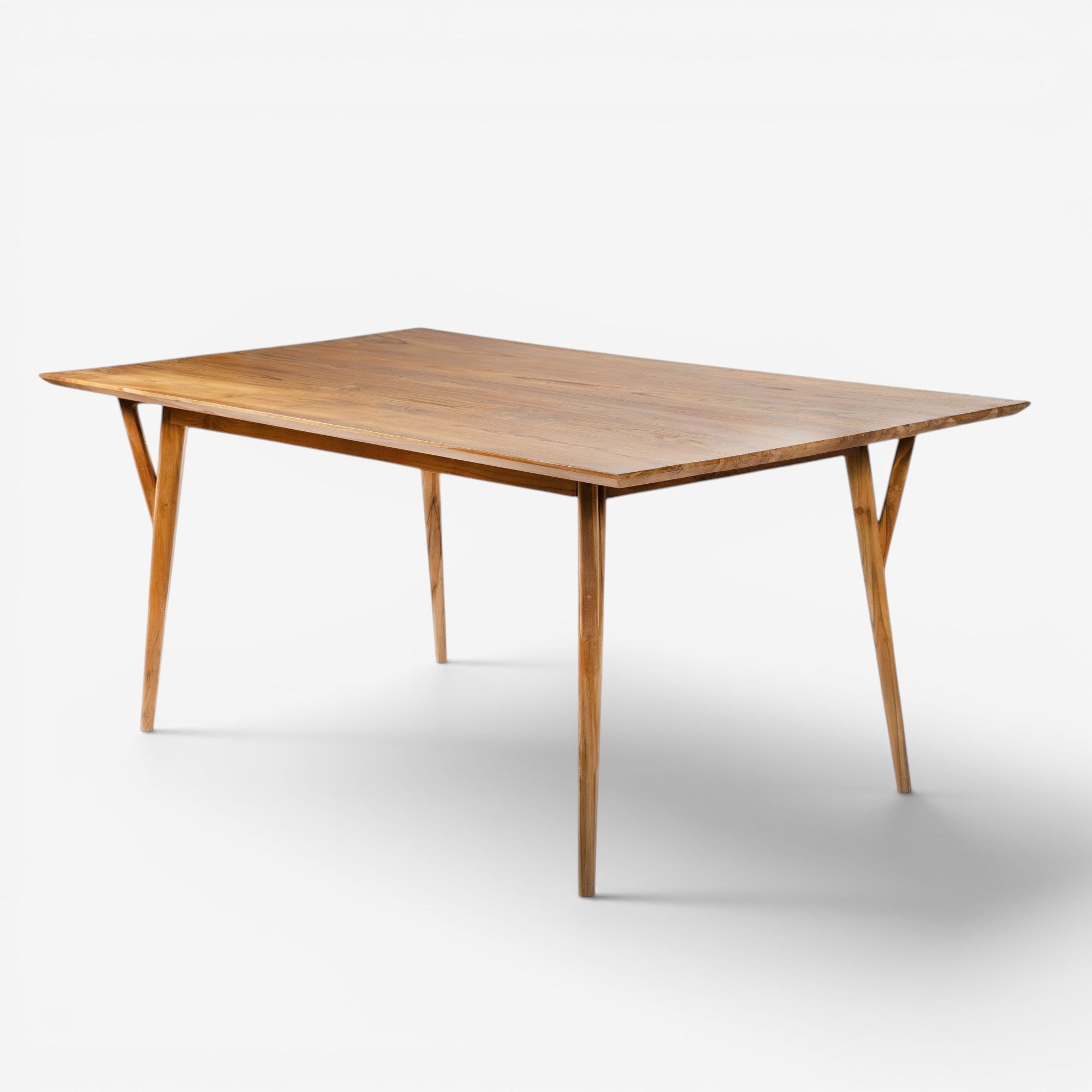 Kayu Living Berawa teak dining table 180x100 cm with natural grain and warm tones, featuring angled legs.