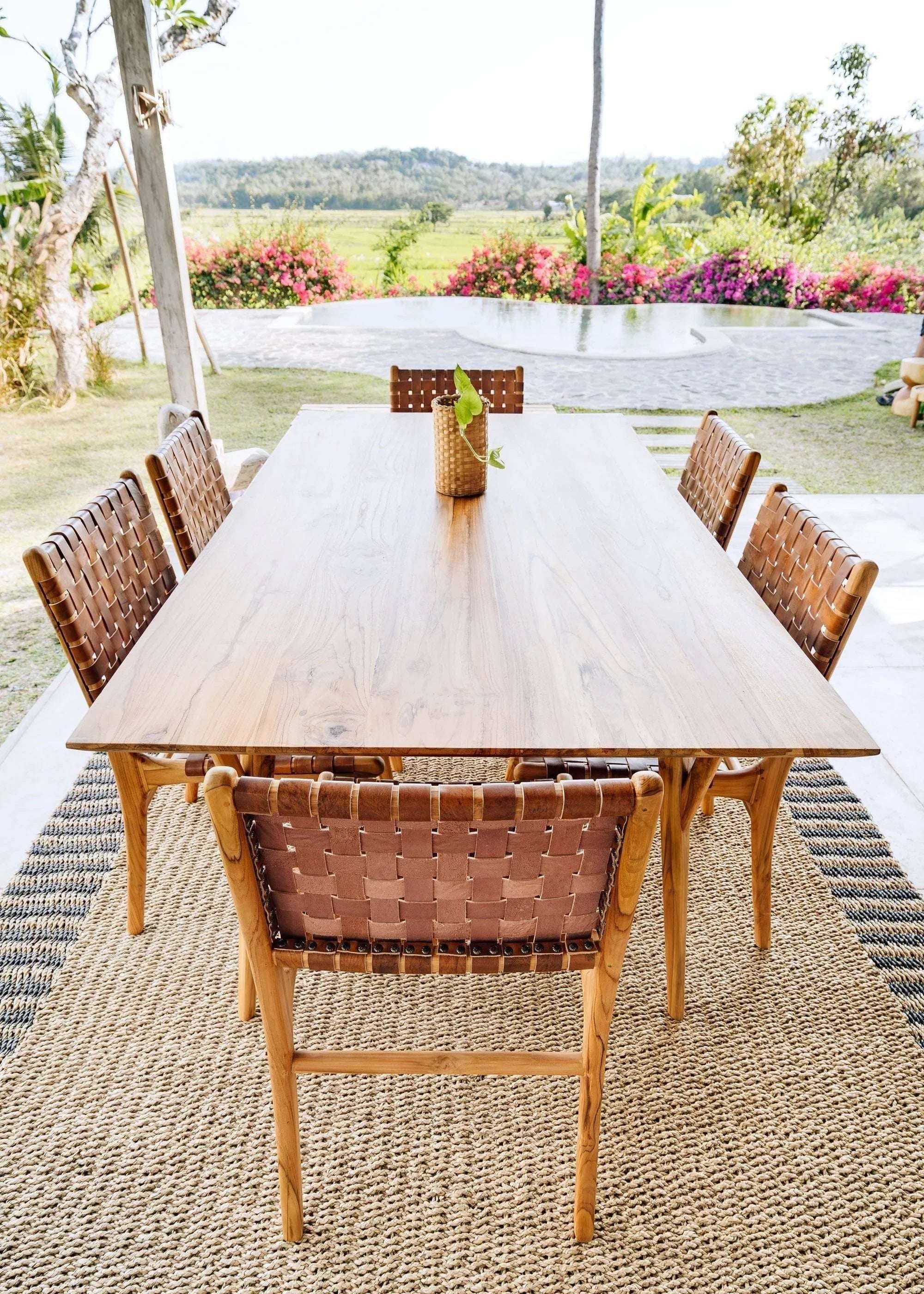 Kayu Living Berawa teak dining table with woven leather chairs, 180x100 cm, natural wood finish.
