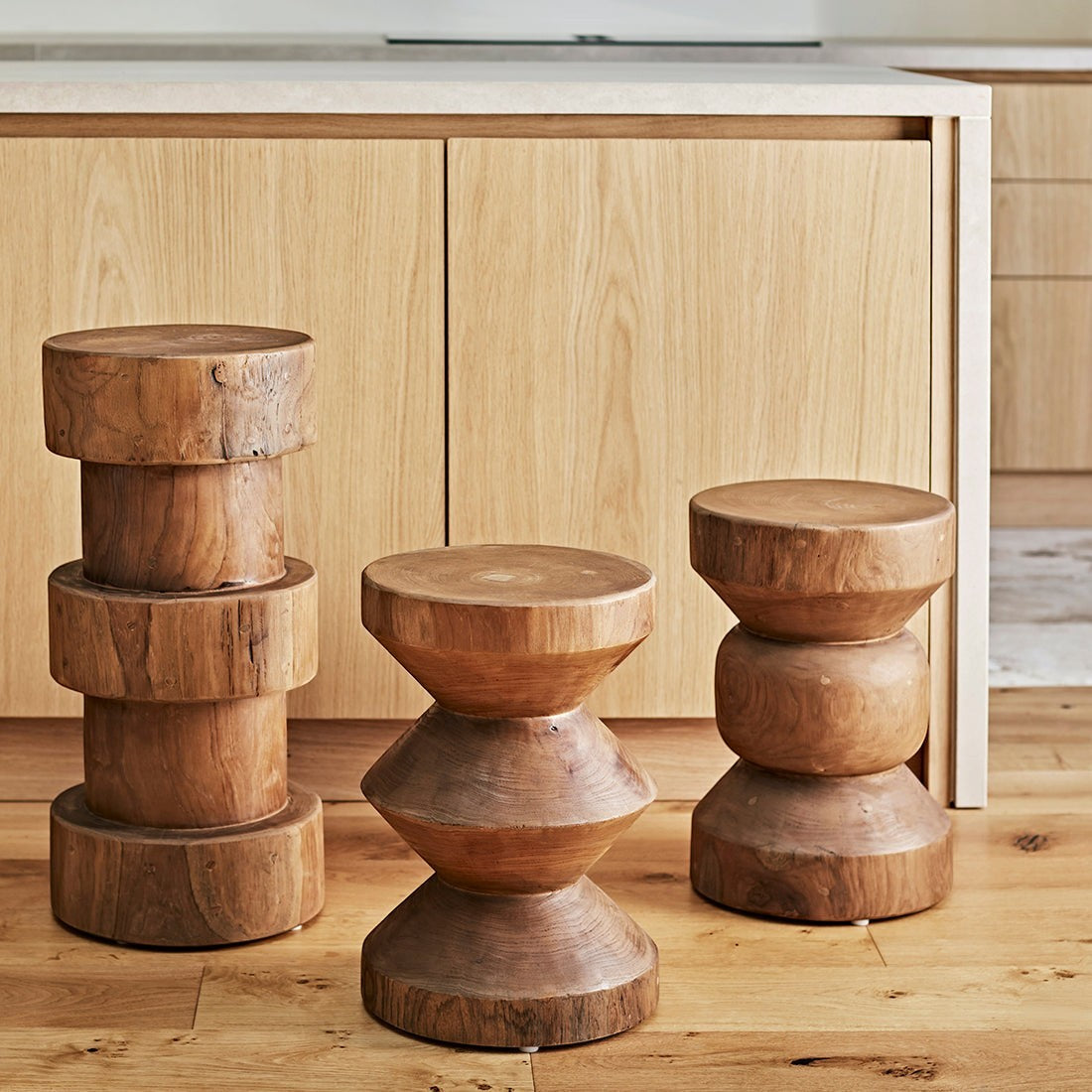 Kayu Living Forma Ritari solid teak side tables with stacked geometric designs in a modern kitchen setting.