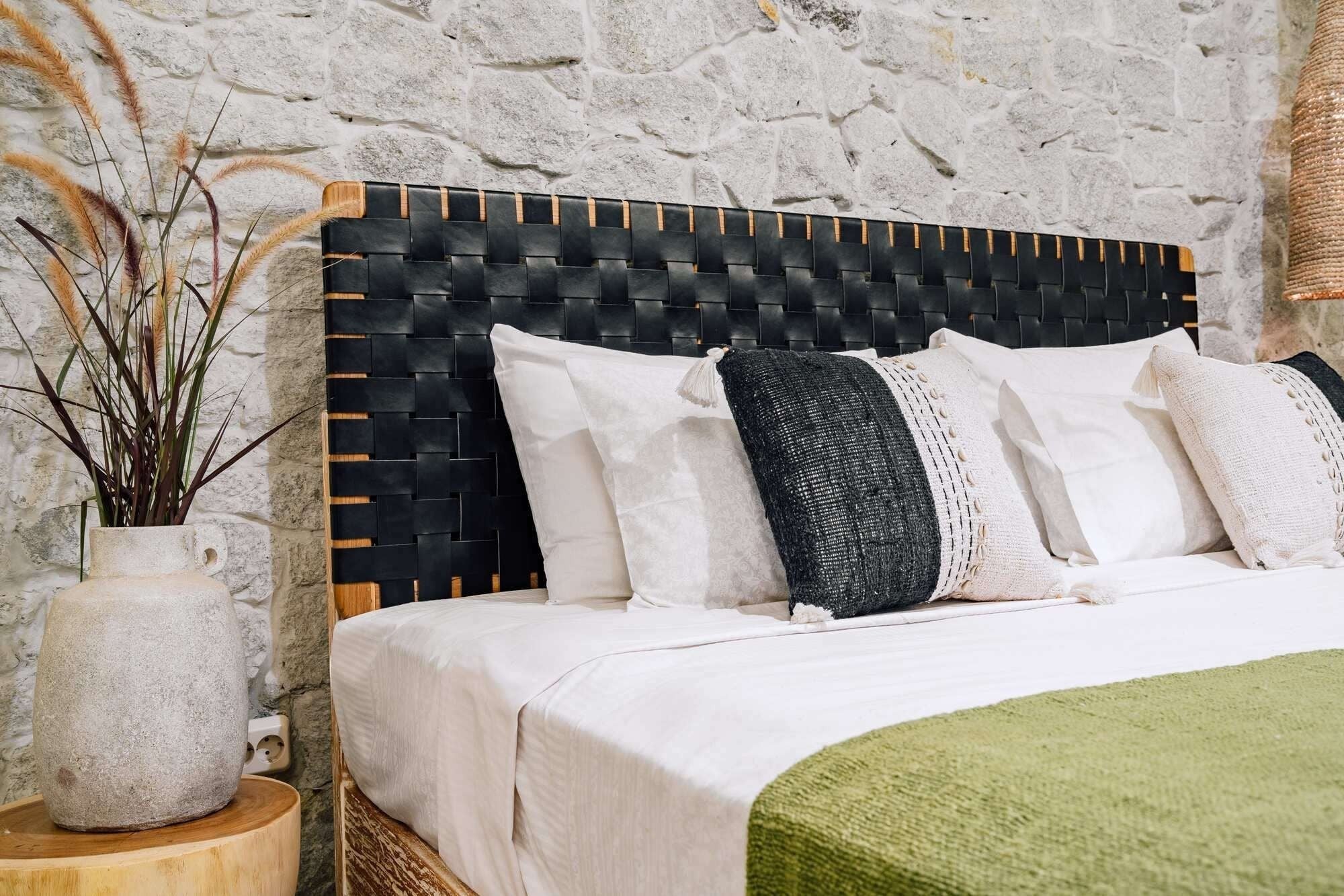 Kayu Living Umalas headboard: handcrafted teak frame with black woven leather straps. Modern artisanal design.