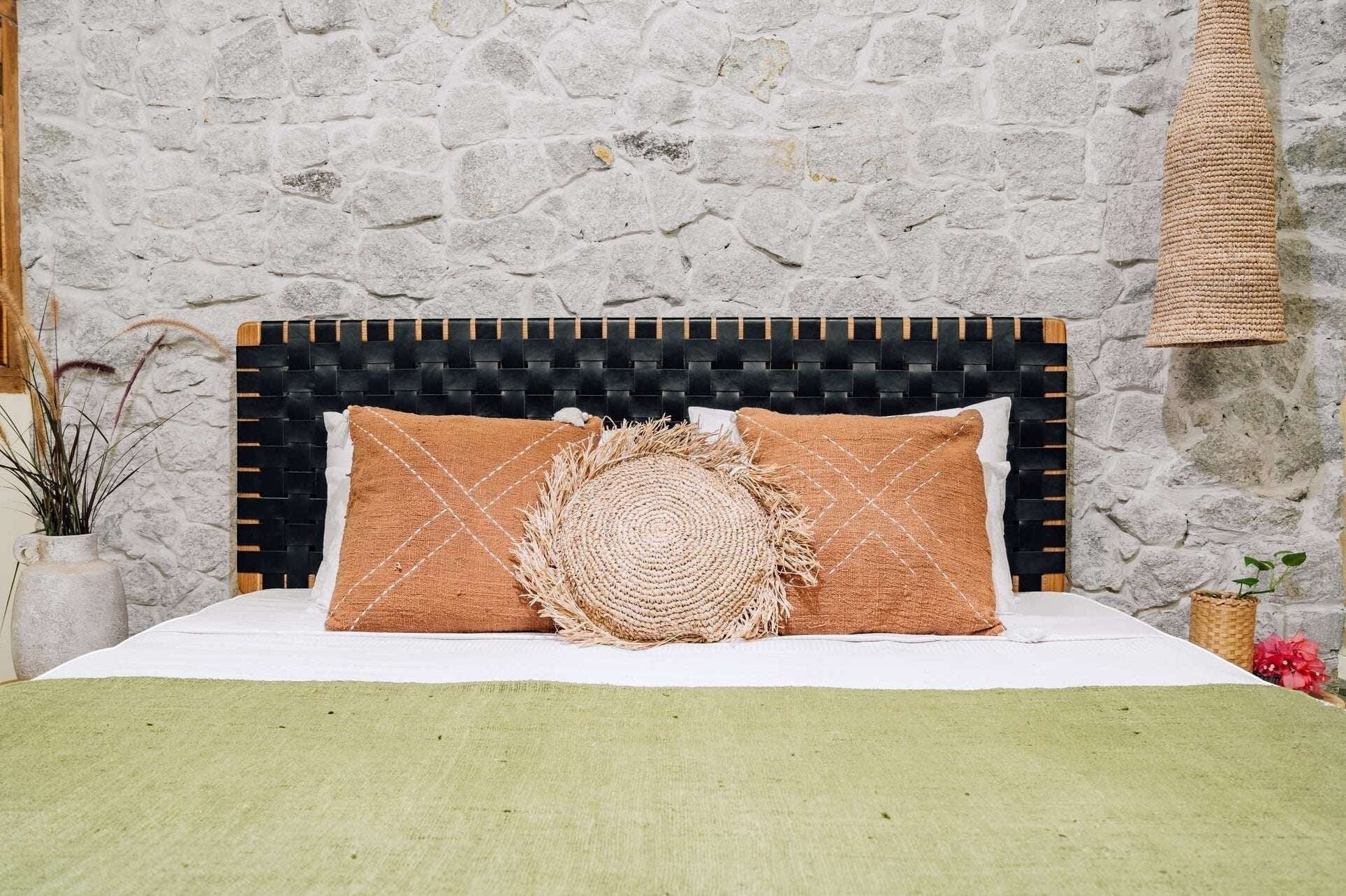 Kayu Living Umalas headboard with black woven leather straps and teak frame. Modern artisanal design.