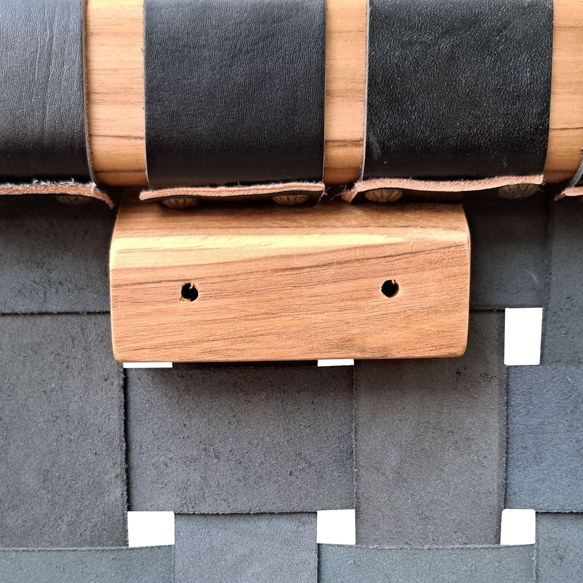 Kayu Living Umalas headboard: handcrafted teak with woven black leather straps and a natural wood accent.