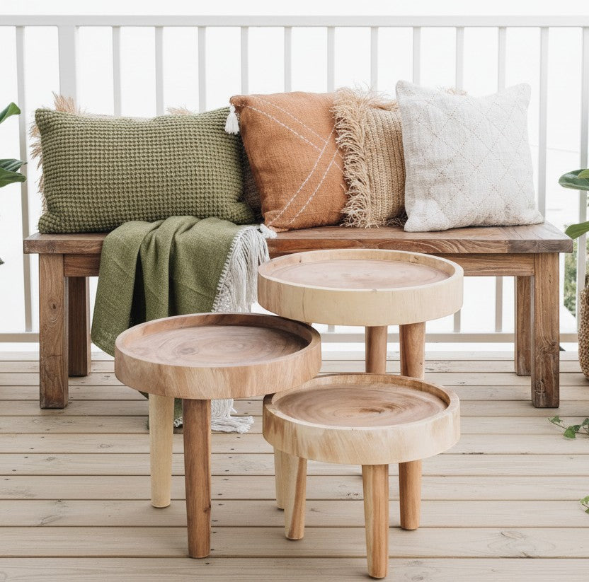 Kayu Living Ulu side table crafted from suar wood with a unique grain pattern and three legs. Natural wood finish.