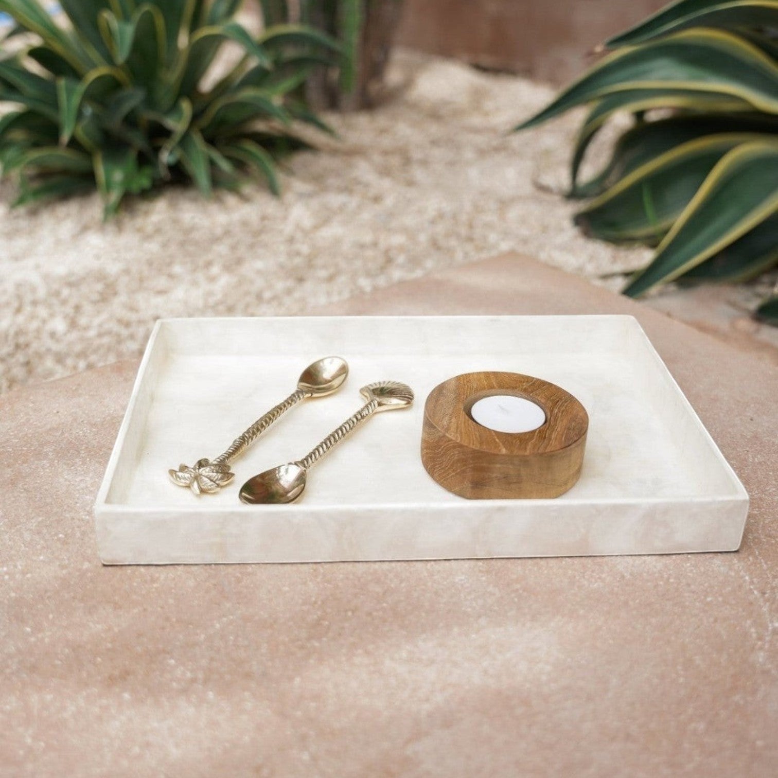 Kayu Living white rectangular Capiz shell tray holding two gold spoons and a small wooden candle holder