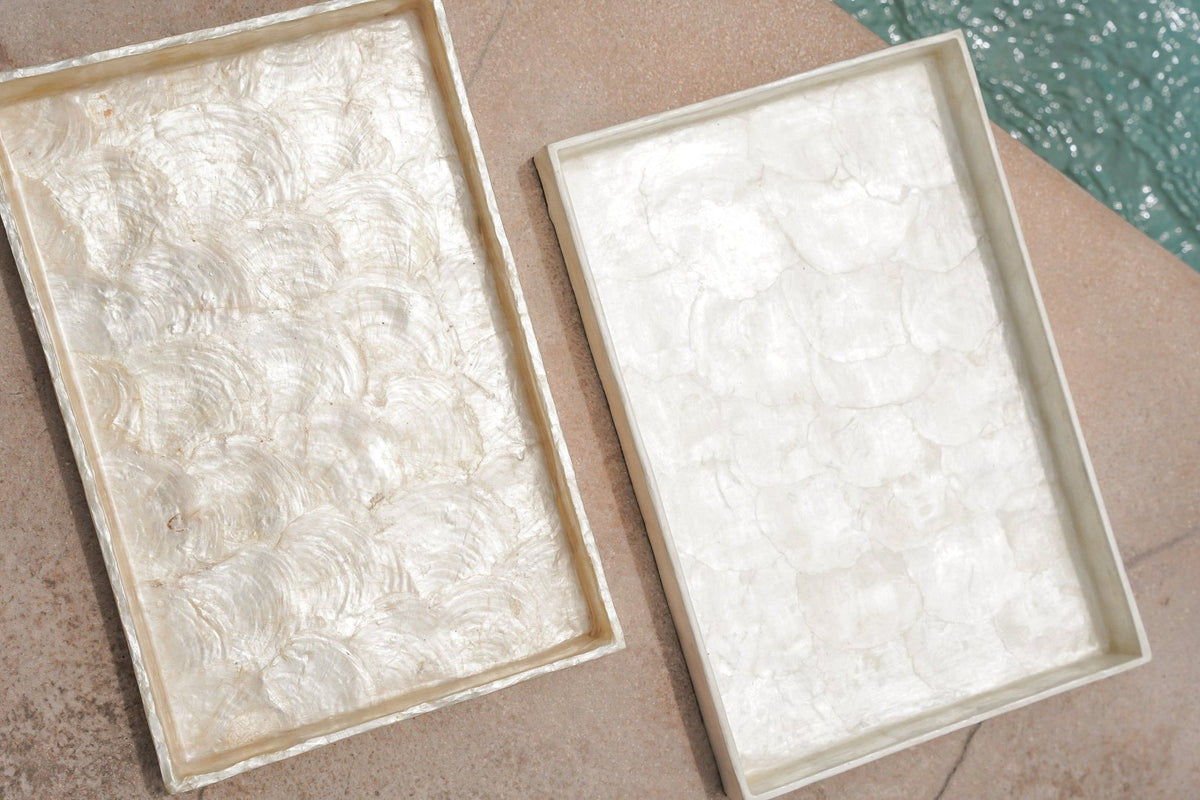 Two rectangular white Kayu Living Capiz shell trays with iridescent, handcrafted textures for home decor.