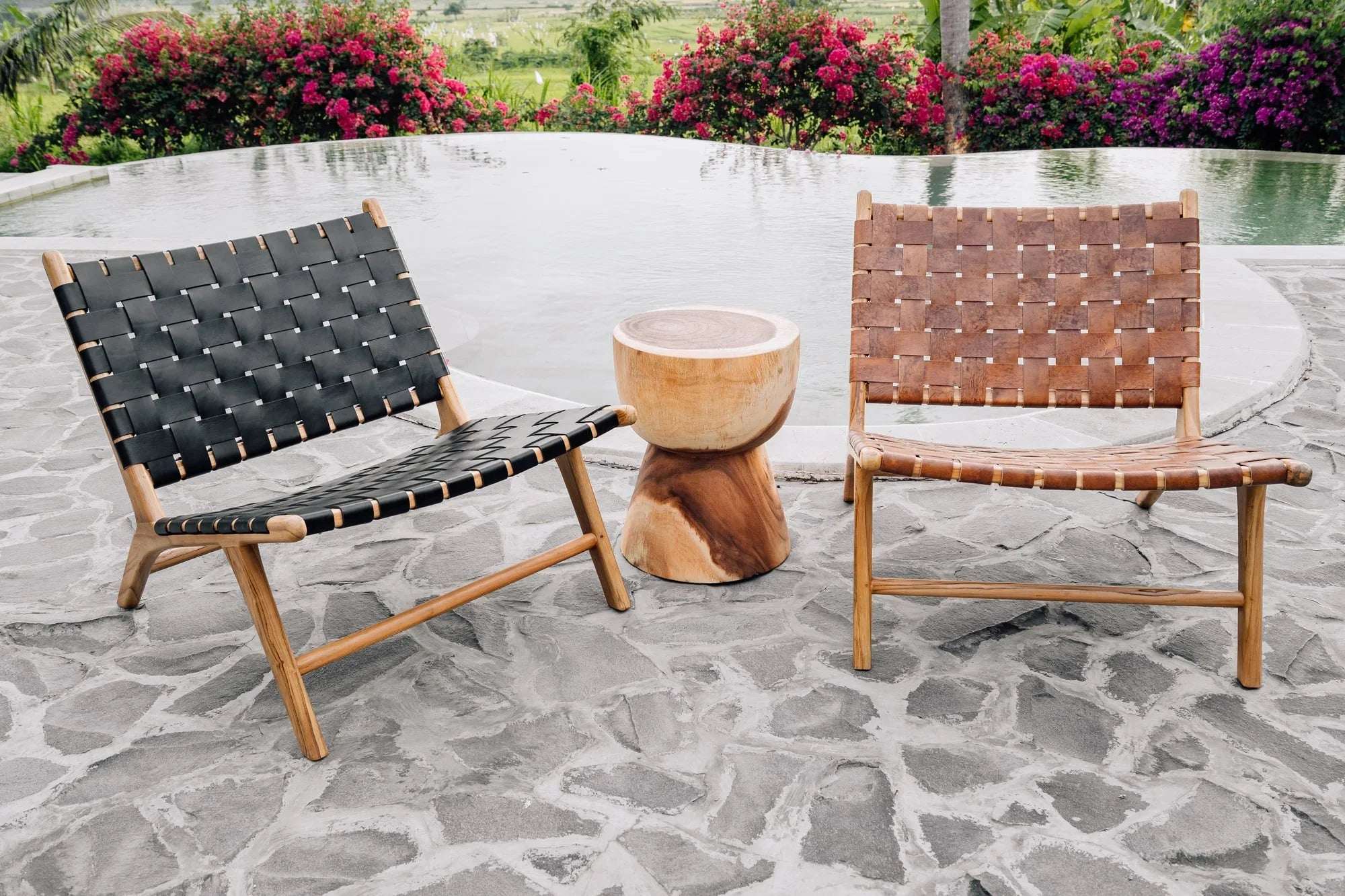 Handmade woven leather chairs and wooden side table by a pool, Kayu Living outdoor furniture