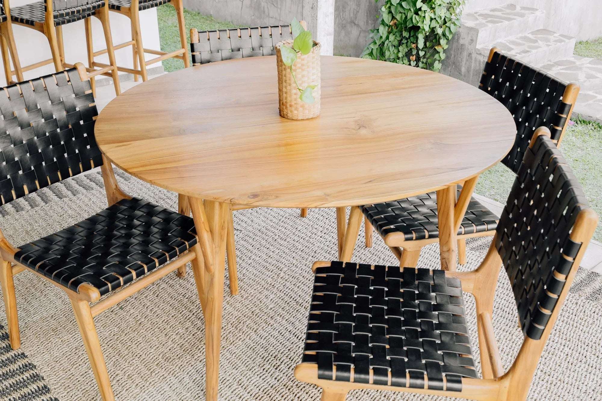 Handcrafted round wooden dining table with woven chairs, Kayu Living outdoor furniture