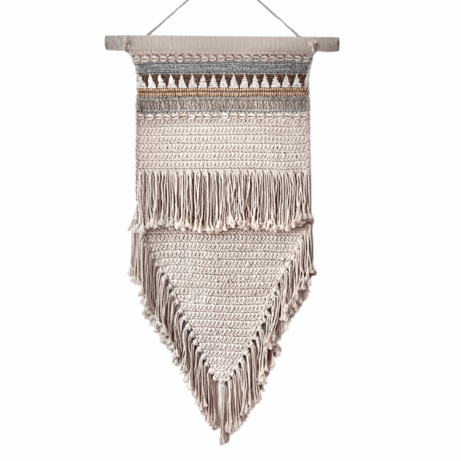 Woven wall hanging with fringe on a white background